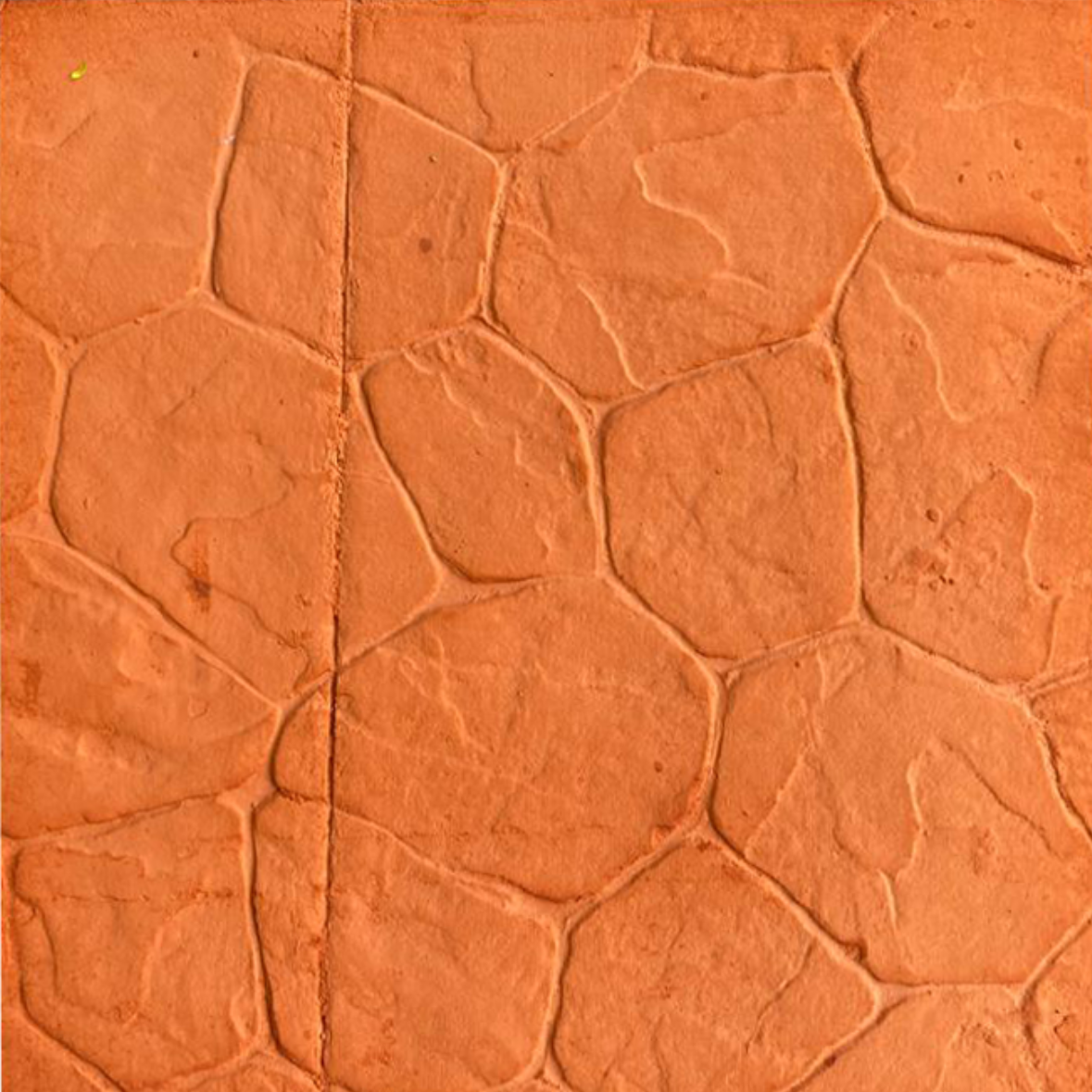 Orange patterned concrete with a cobblestone-like design, featuring thick, raised lines and a central vertical seam.