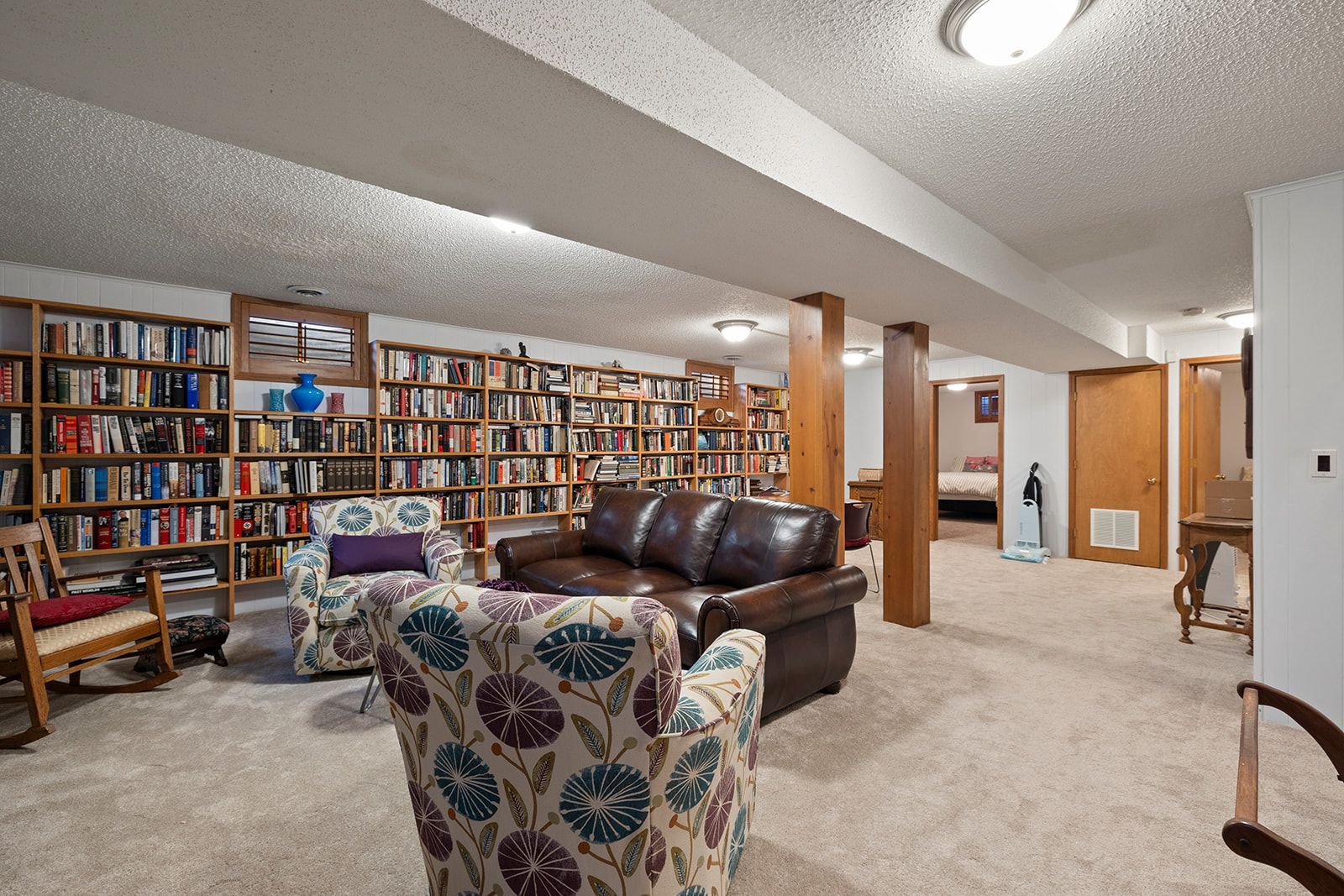 A living room filled with furniture and bookshelves.