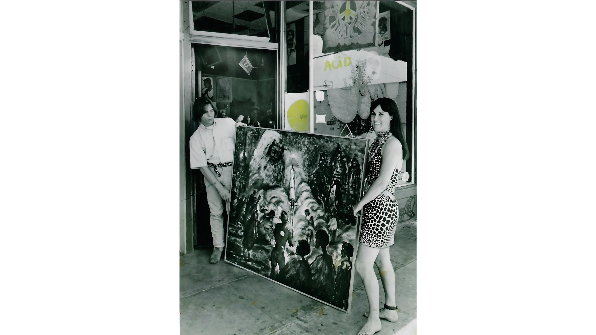A person 's hands are laying on top of a pile of books