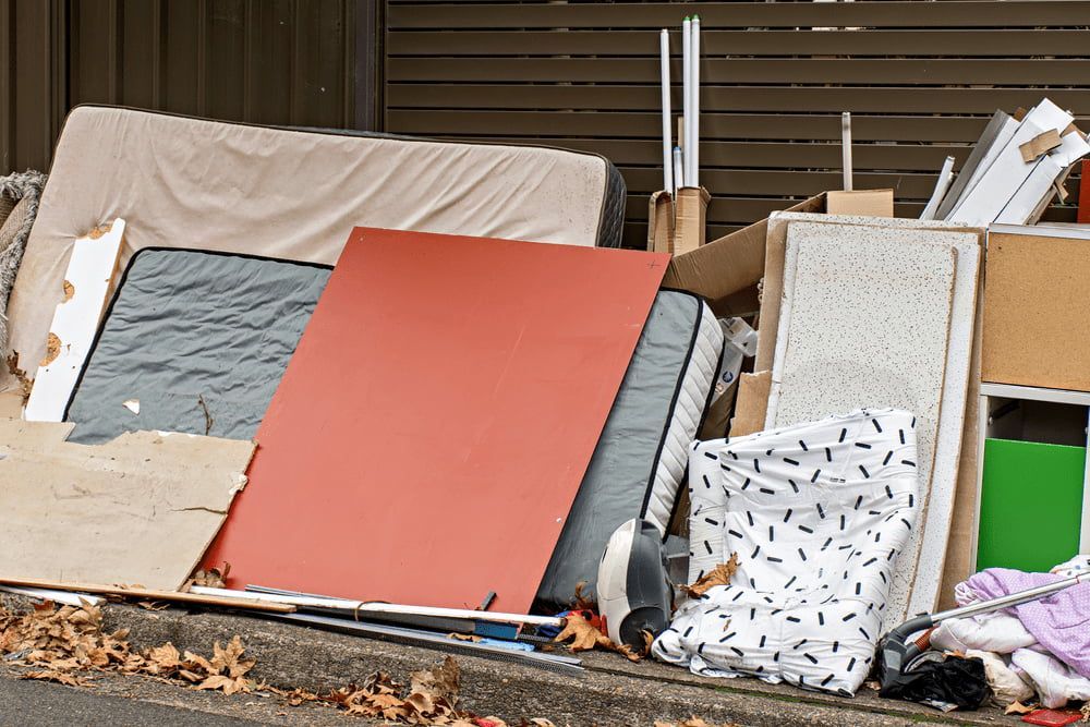 A Pile of Junk Is Sitting on The Side of The Road — Handi Skips in Bohle, QLD