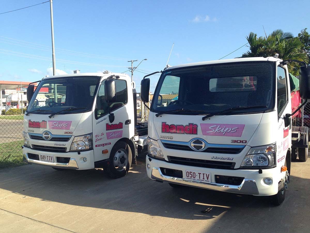 Two White Trucks Are Parked Next to Each Other on the Side of the Road — Handi Skips in Bohle, QLD