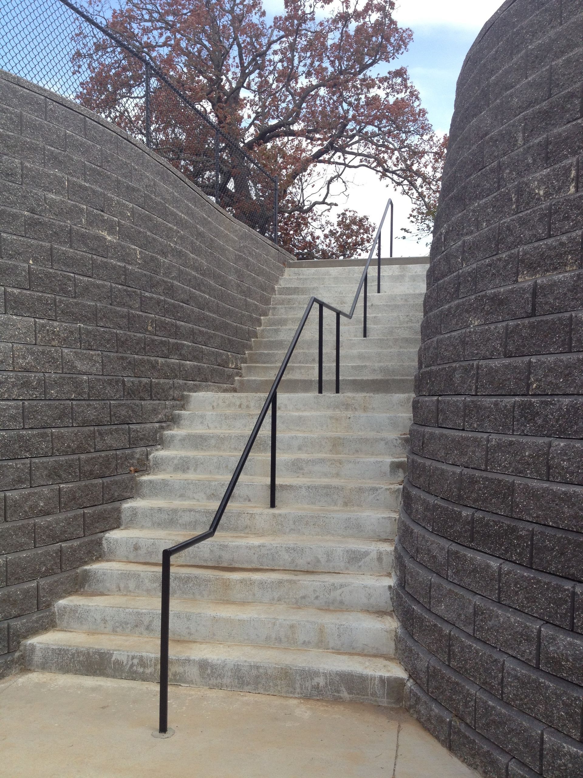 A set of stairs leading up to a brick wall