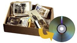 A cardboard box filled with old photographs and a cd.