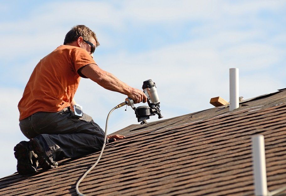 Professional roofing contractor repairing a residential roof in Wollongong, NSW.