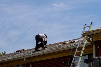 Expert and experienced roofers working in a damaged residential roof in Wollongong NSW.