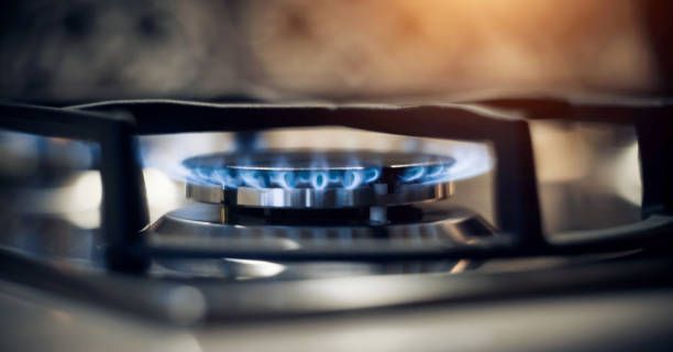 Modern kitchen showcasing residential propane in use on a gas stove with a blazing flame.