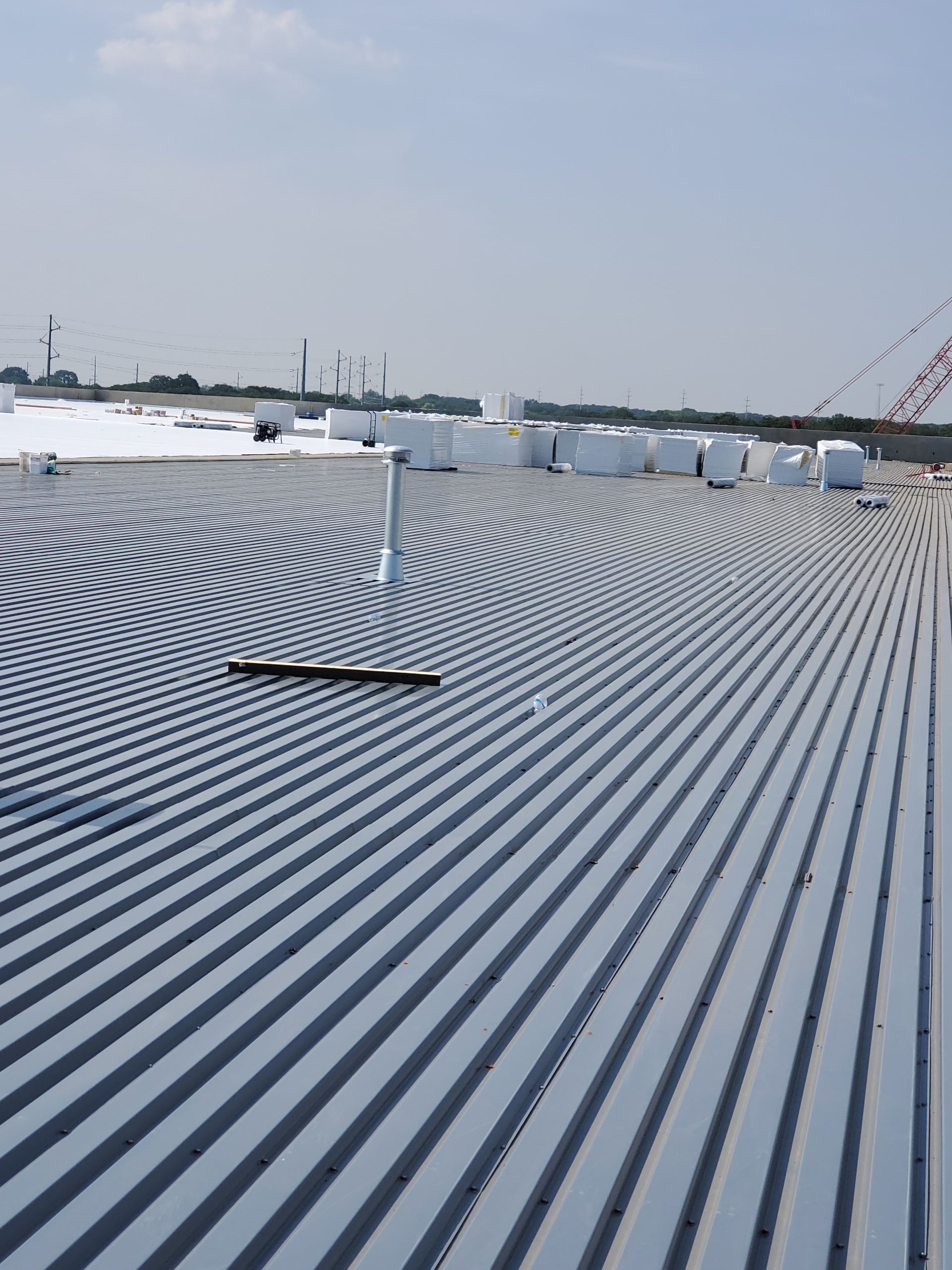 Corrugated metal roof on a building under construction, view from above.