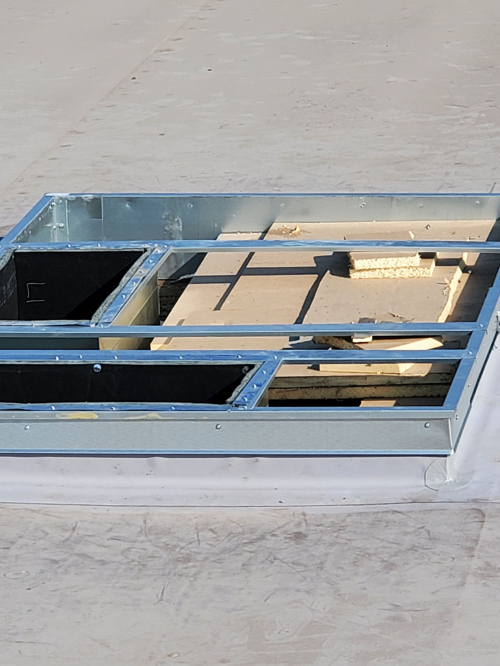 Metal frame structure on a flat roof, possibly for HVAC equipment.
