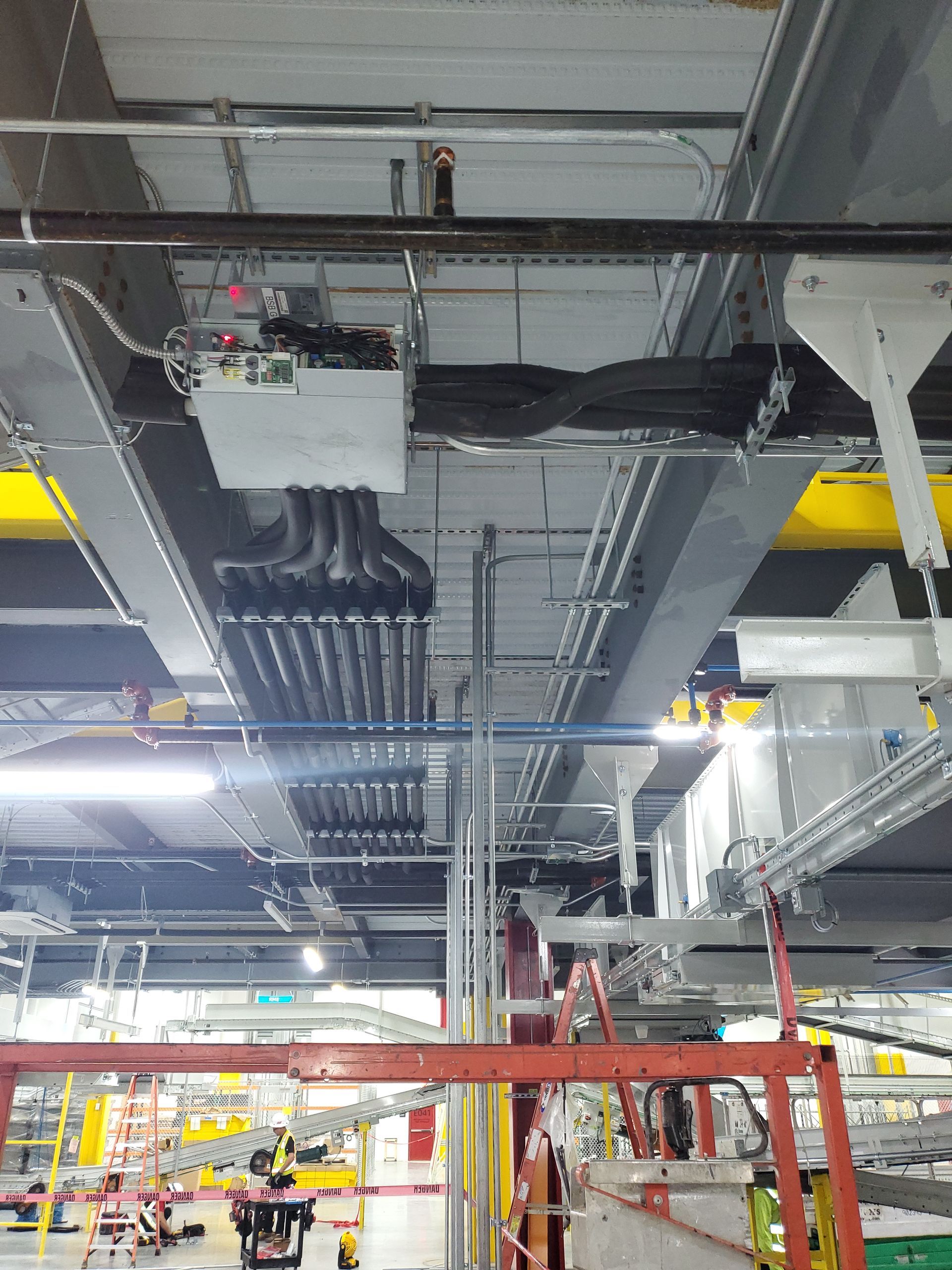 Industrial ceiling with electrical wiring and equipment.