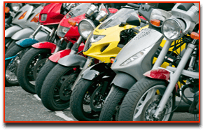 A close up of the front of motorbikes all lined up in a row