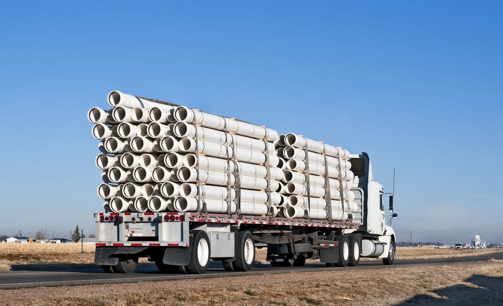 A Semi Truck is Carrying a Stack of Pipes — Supersonic Couriers In Emerald, QLD