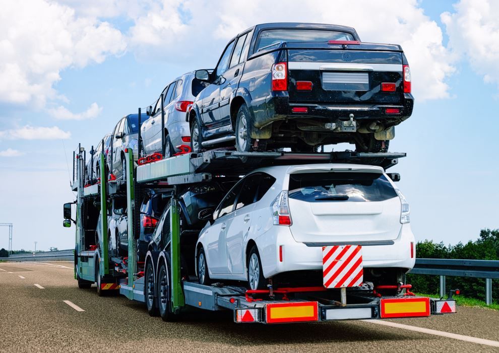 A Truck is Carrying a Row of Cars on a Highway — Supersonic Couriers In Emerald, QLD