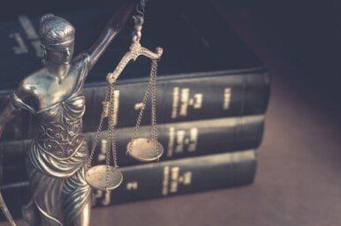 Small Business Attorney — Lady Justice Statue and Law Books —