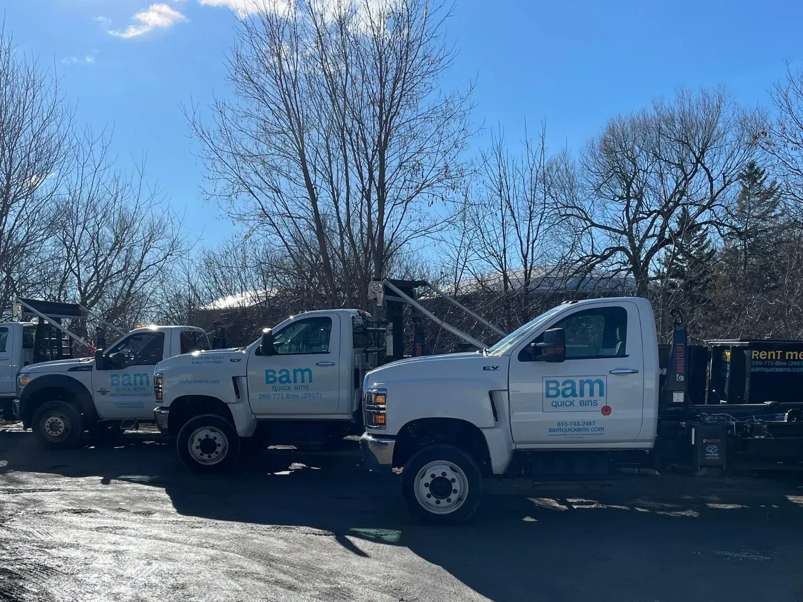 Three white work trucks with 