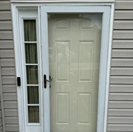 A wooden door with a welcome mat in front of it