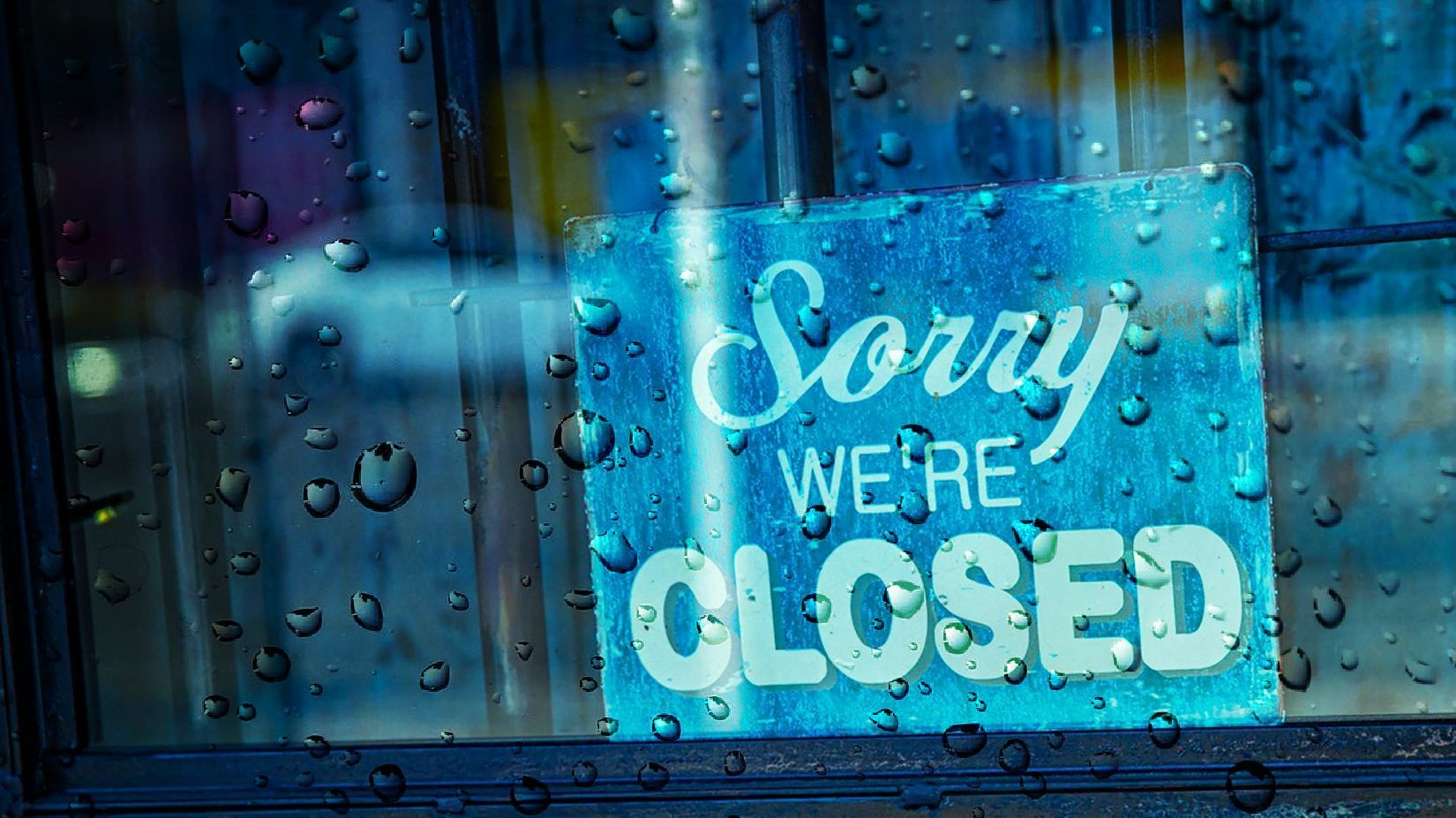 A sign on a window that says `` sorry we 're closed ''.