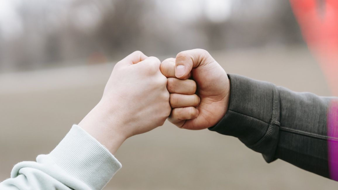 building trust RPIE-Based PR fist bump between a man and a women.