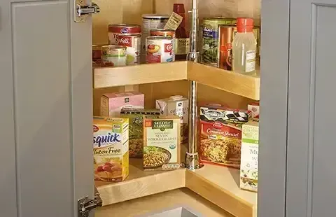 Corner kitchen cabinet with shelves of assorted canned and boxed food items
