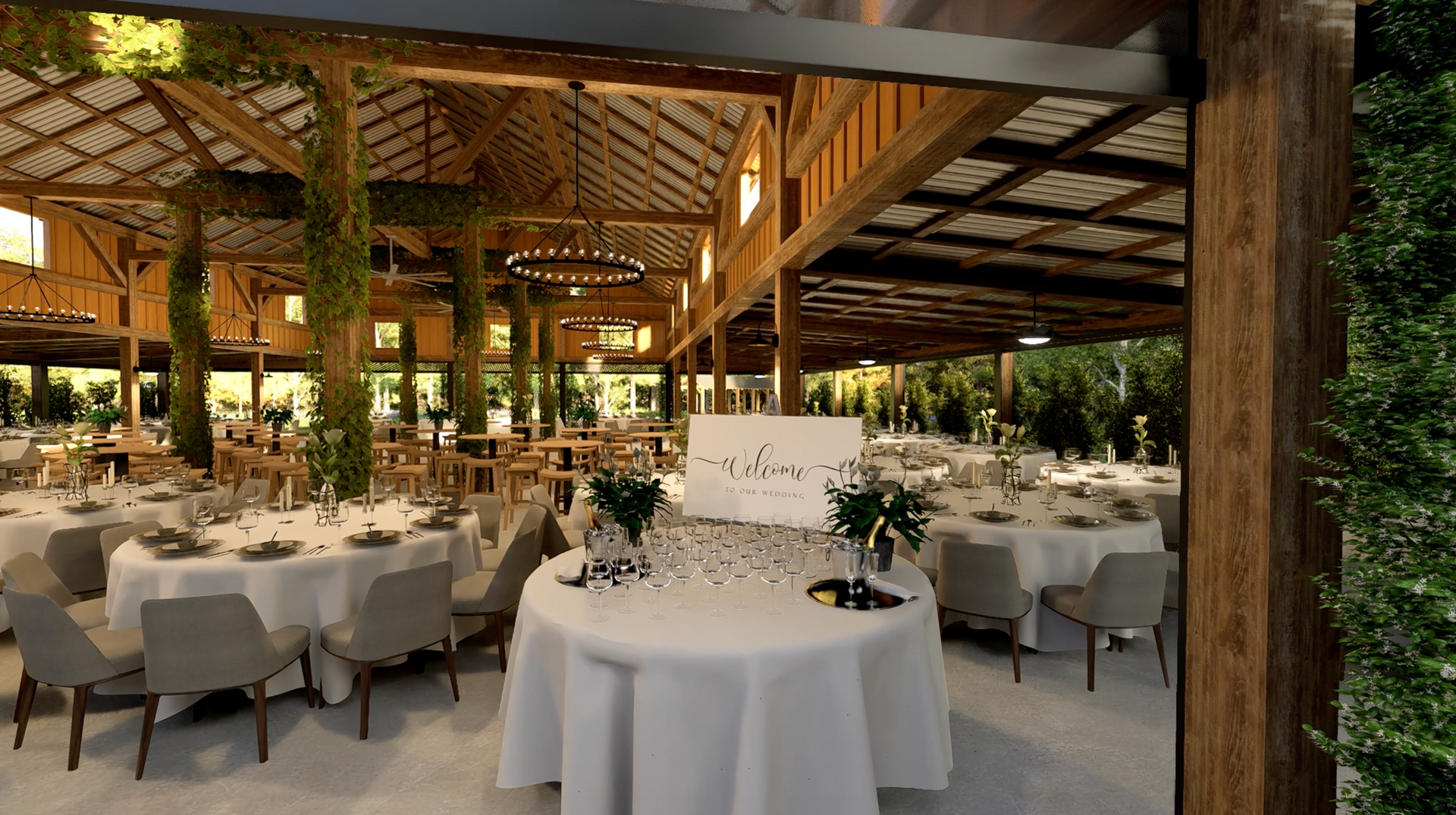 Wedding reception in a barn with round tables, white linens, and modern chairs.