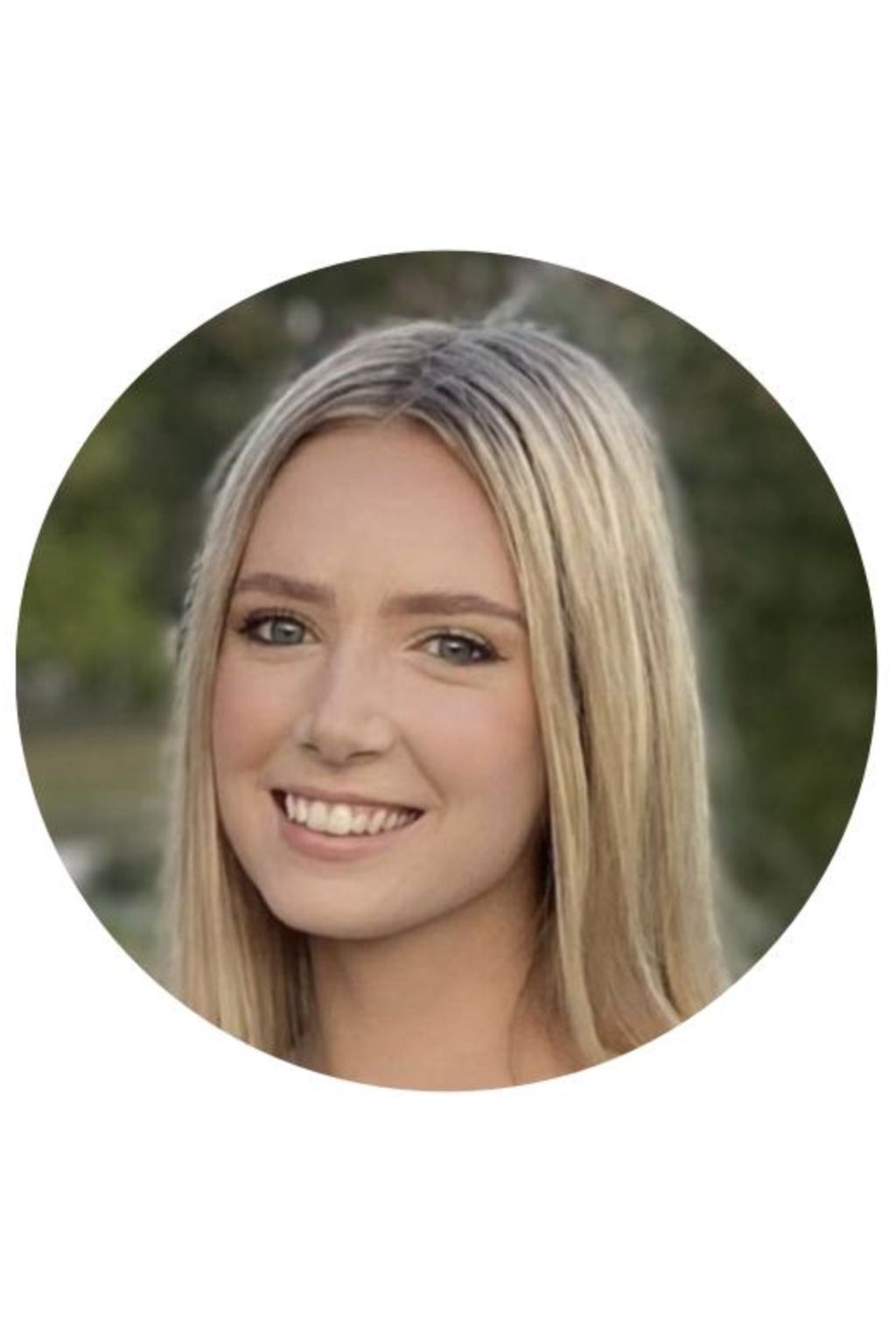 Smiling woman with long blonde hair, outdoors.