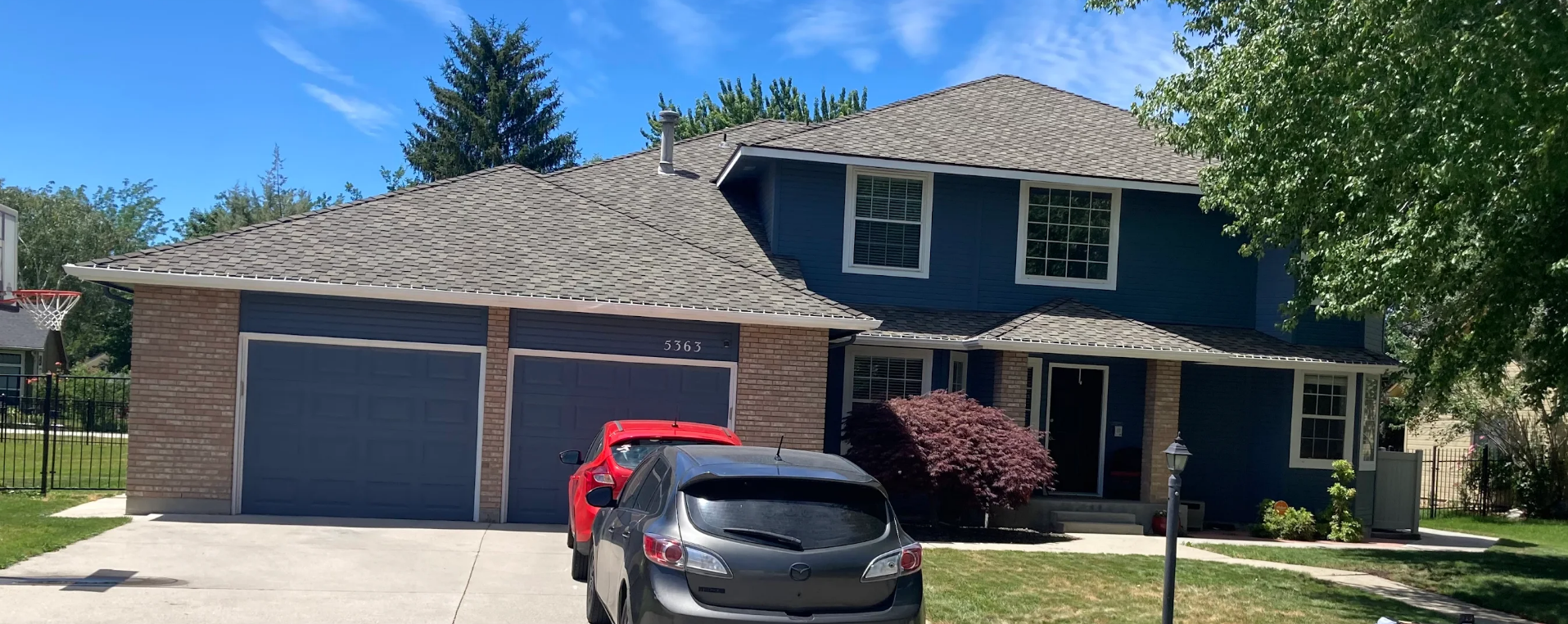 A Blue House With A Red Truck Parked In Front Of It — Caldwell, ID — Busy Bee Painting