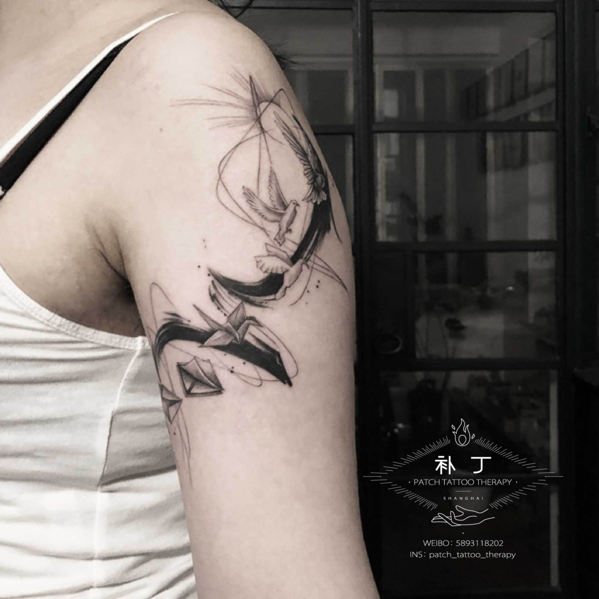Armband tattoo of a flying bird transformed from a sealed envelope and paper plane origami bird in geometric style designed by Jingxi Gu at Patch Tattoo Therapy - angle 3
