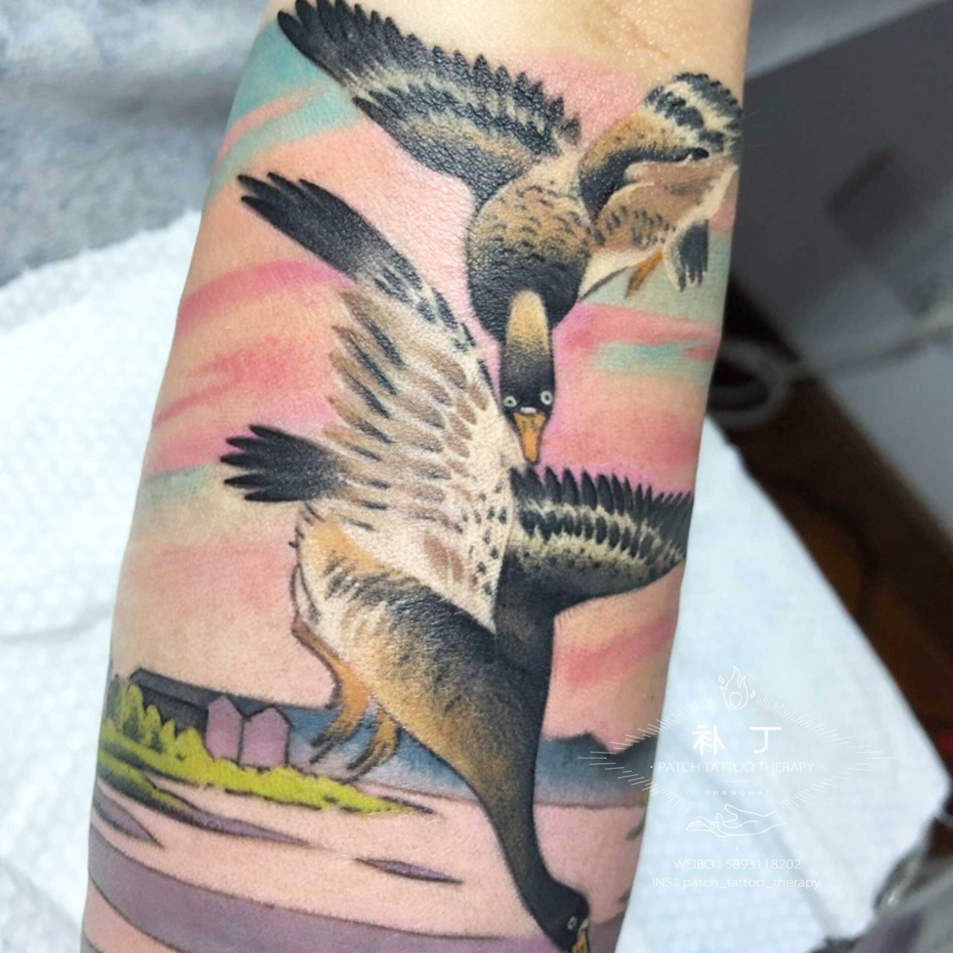 Forearm sleeve tattoo of a peaceful scene featuring a boat, lake, ducks, and rustic buildings in Japanese styled color designed by Jingxi Gu at Patch Tattoo Therapy - angle 4