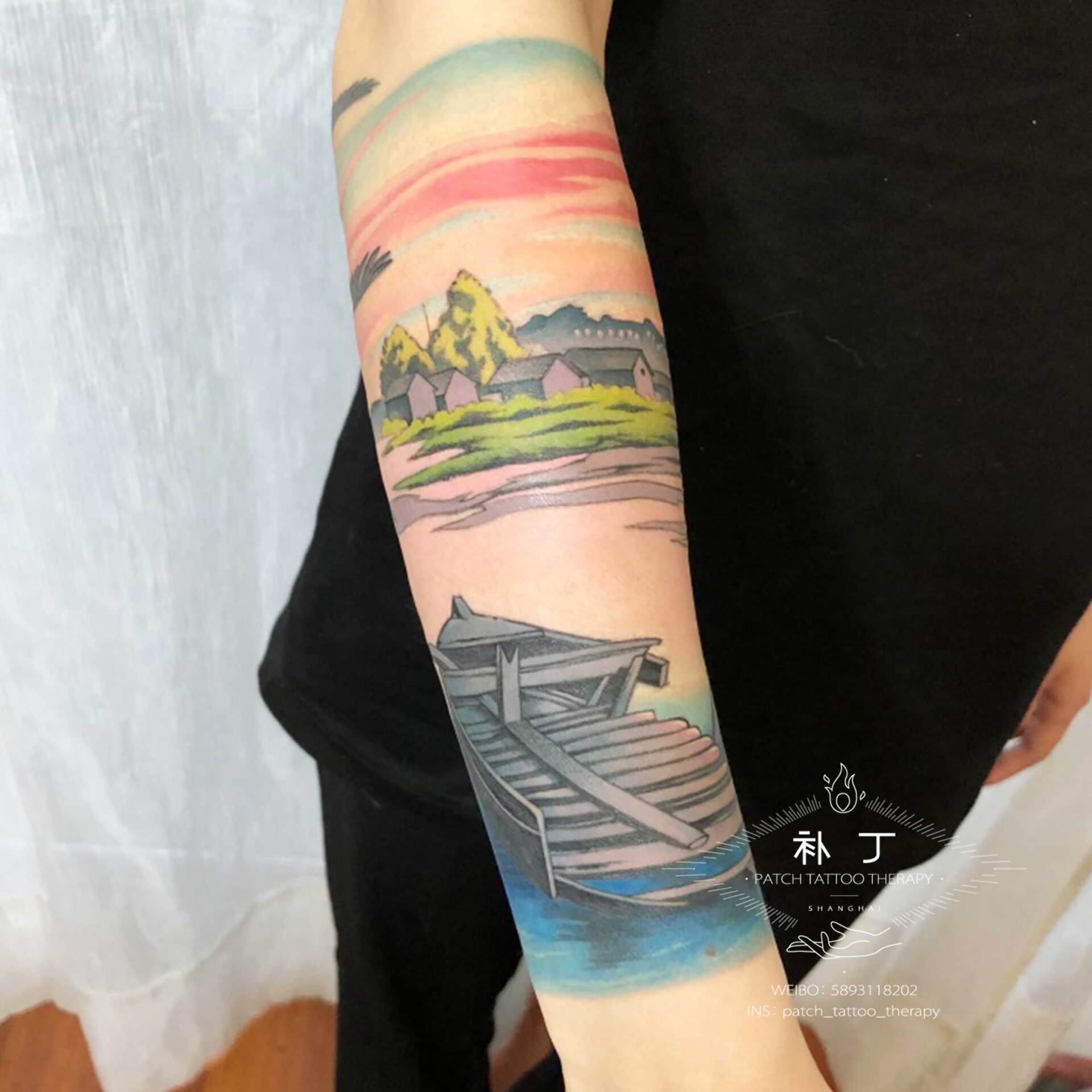 Forearm sleeve tattoo of a peaceful scene featuring a boat, lake, ducks, and rustic buildings in Japanese styled color designed by Jingxi Gu at Patch Tattoo Therapy - angle 5