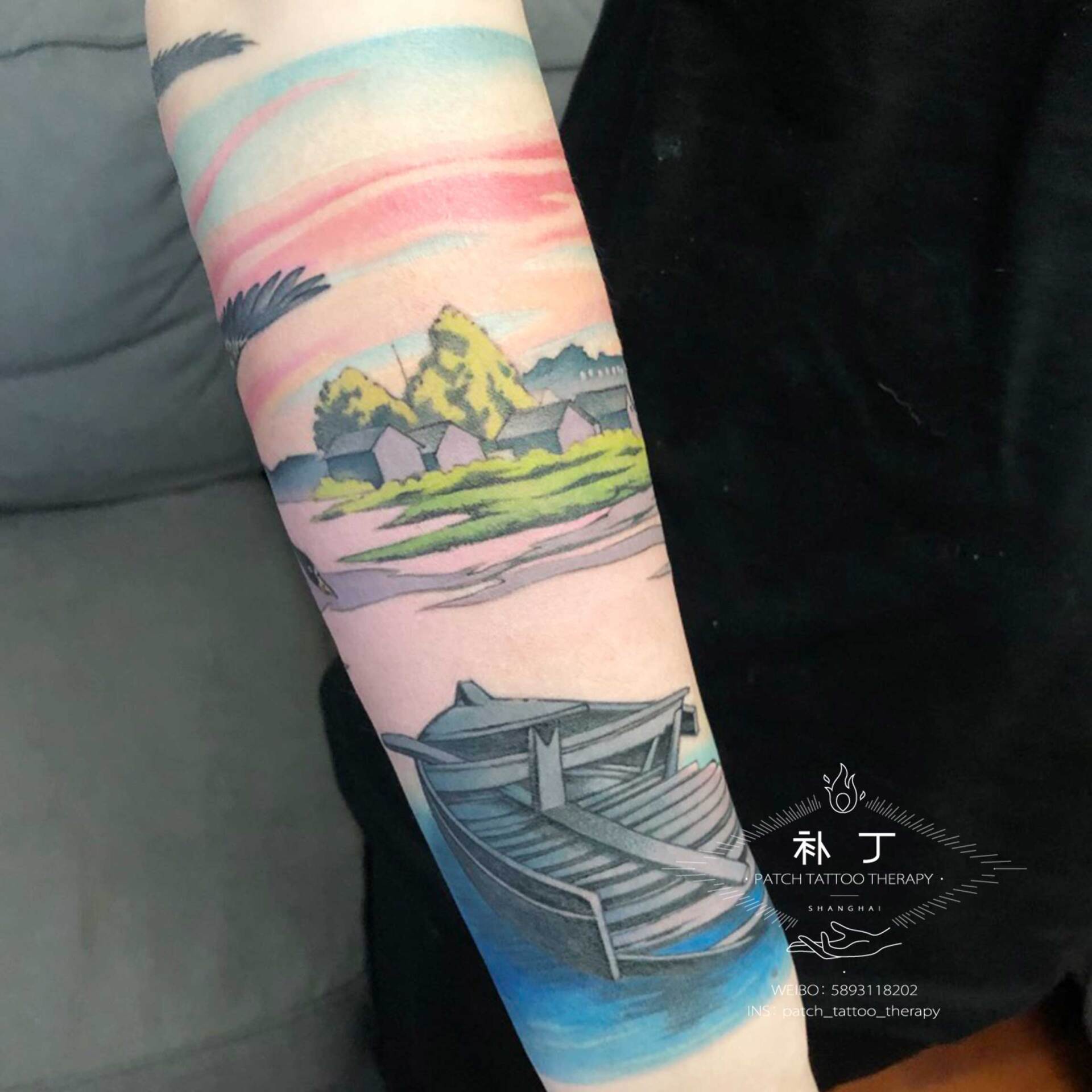 Forearm sleeve tattoo of a peaceful scene featuring a boat, lake, ducks, and rustic buildings in Japanese styled color designed by Jingxi Gu at Patch Tattoo Therapy - angle 6