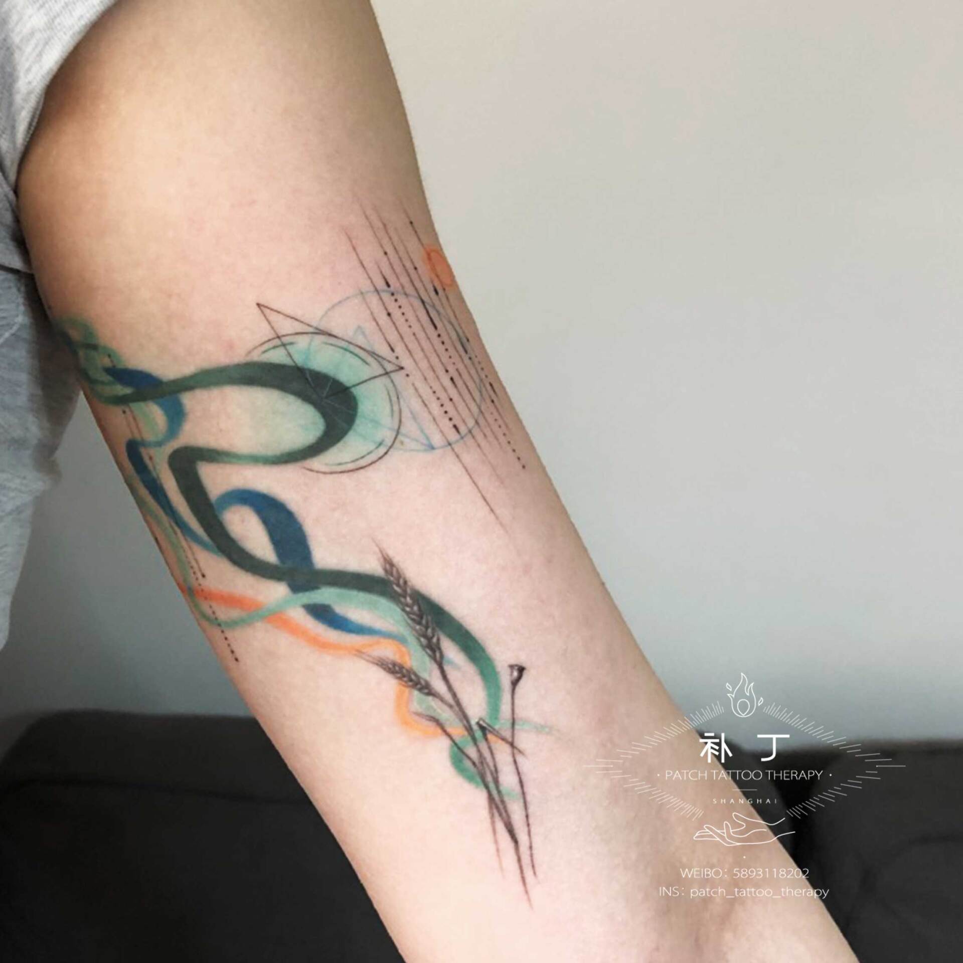 Inner arm tattoo of wheat with playful colored smoke and geometric shapes done designed by Jingxi Gu at Patch Tattoo Therapy - angle 1