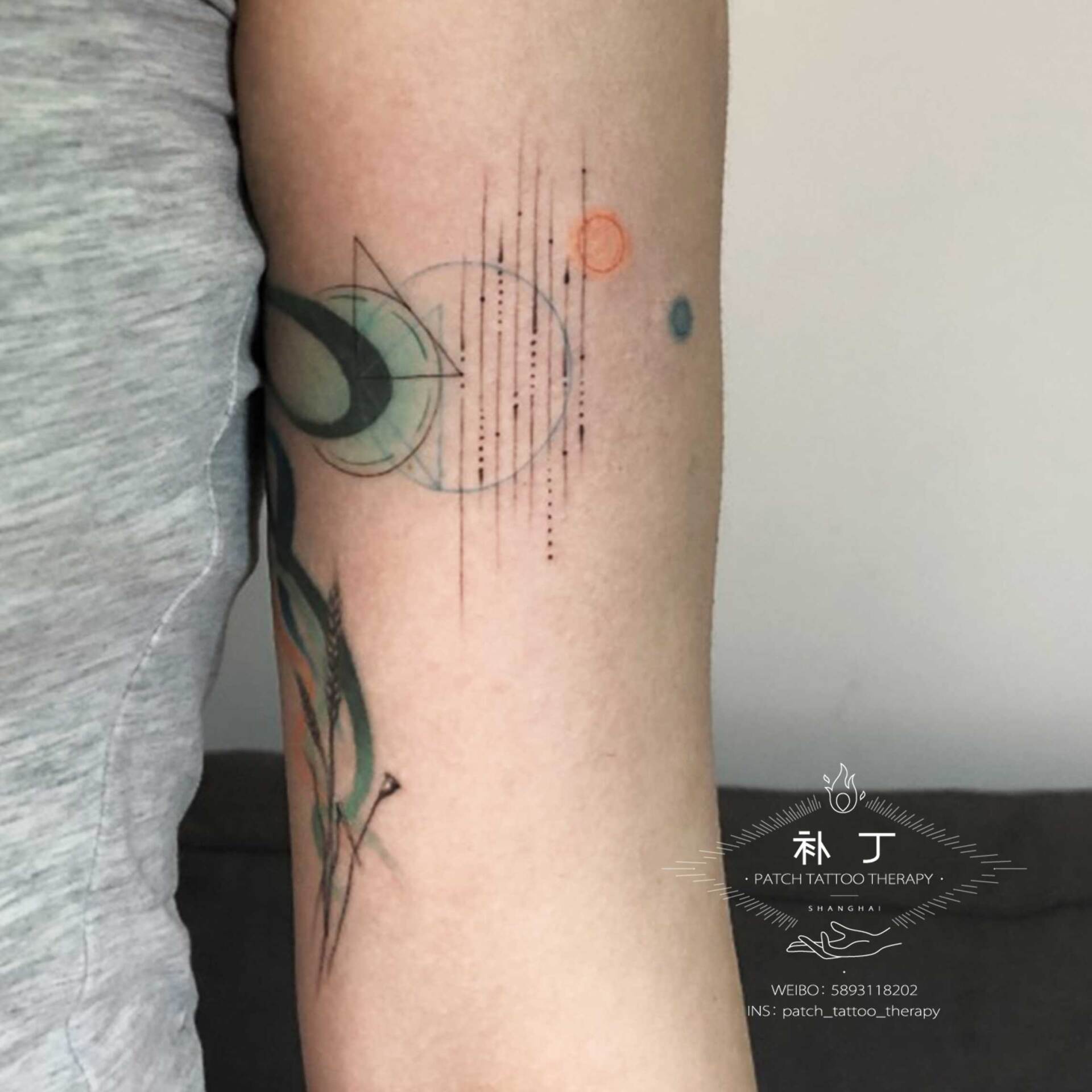 Inner arm tattoo of wheat with playful colored smoke and geometric shapes done designed by Jingxi Gu at Patch Tattoo Therapy - angle 2