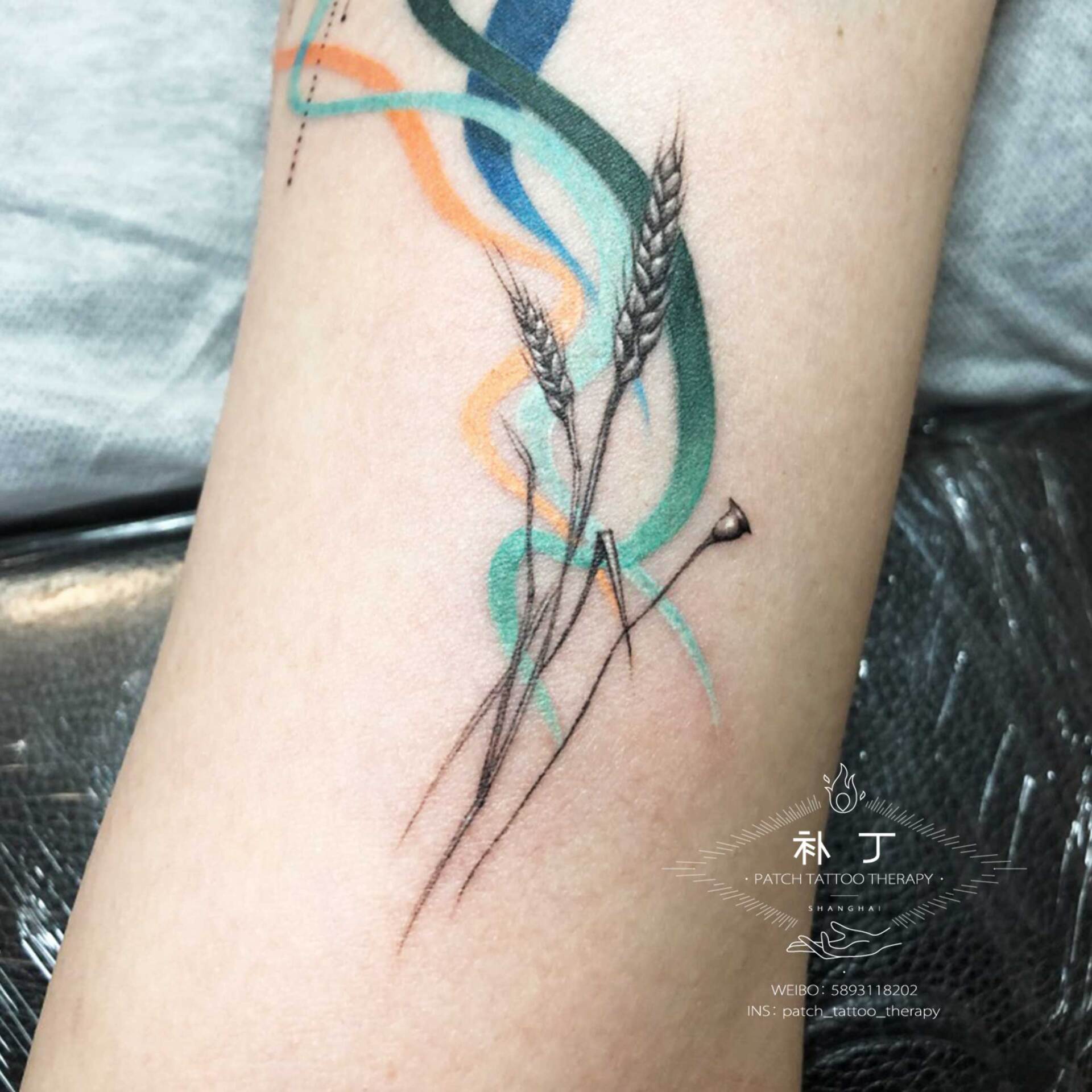 Inner arm tattoo of wheat with playful colored smoke and geometric shapes done designed by Jingxi Gu at Patch Tattoo Therapy - angle 4