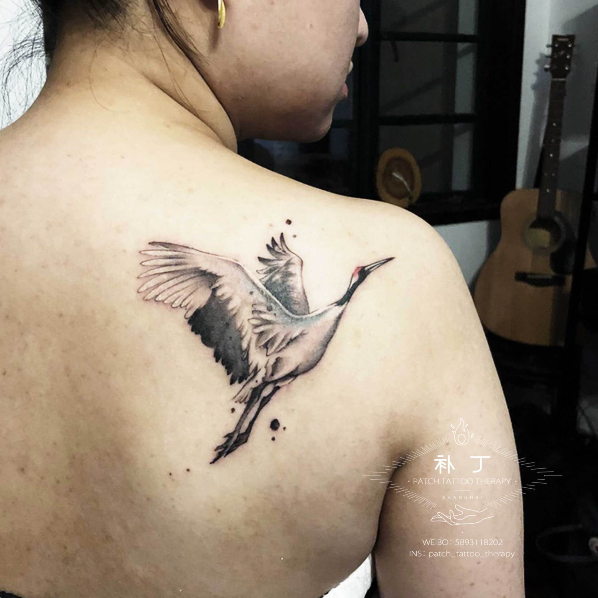 Back tattoo of a flying crane in painting style designed by Jingxi Gu at Patch Tattoo Therapy
