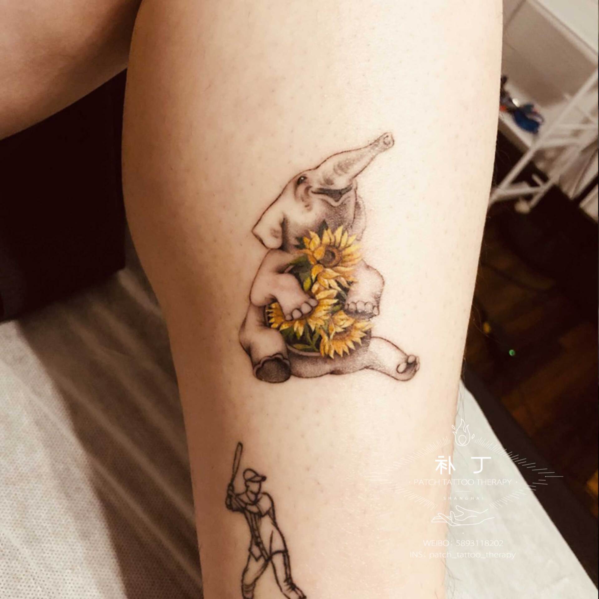 Outside calf tattoo of a cute elephant holding flowers done in color designed by Jingxi Gu at Patch Tattoo Therapy