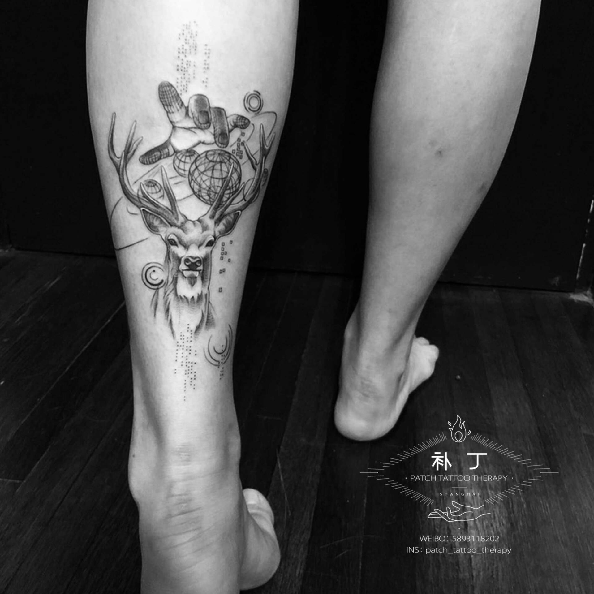 Back calf tattoo of a deer, planets, and a hand in geometric style designed by Jingxi Gu at Patch Tattoo Therapy