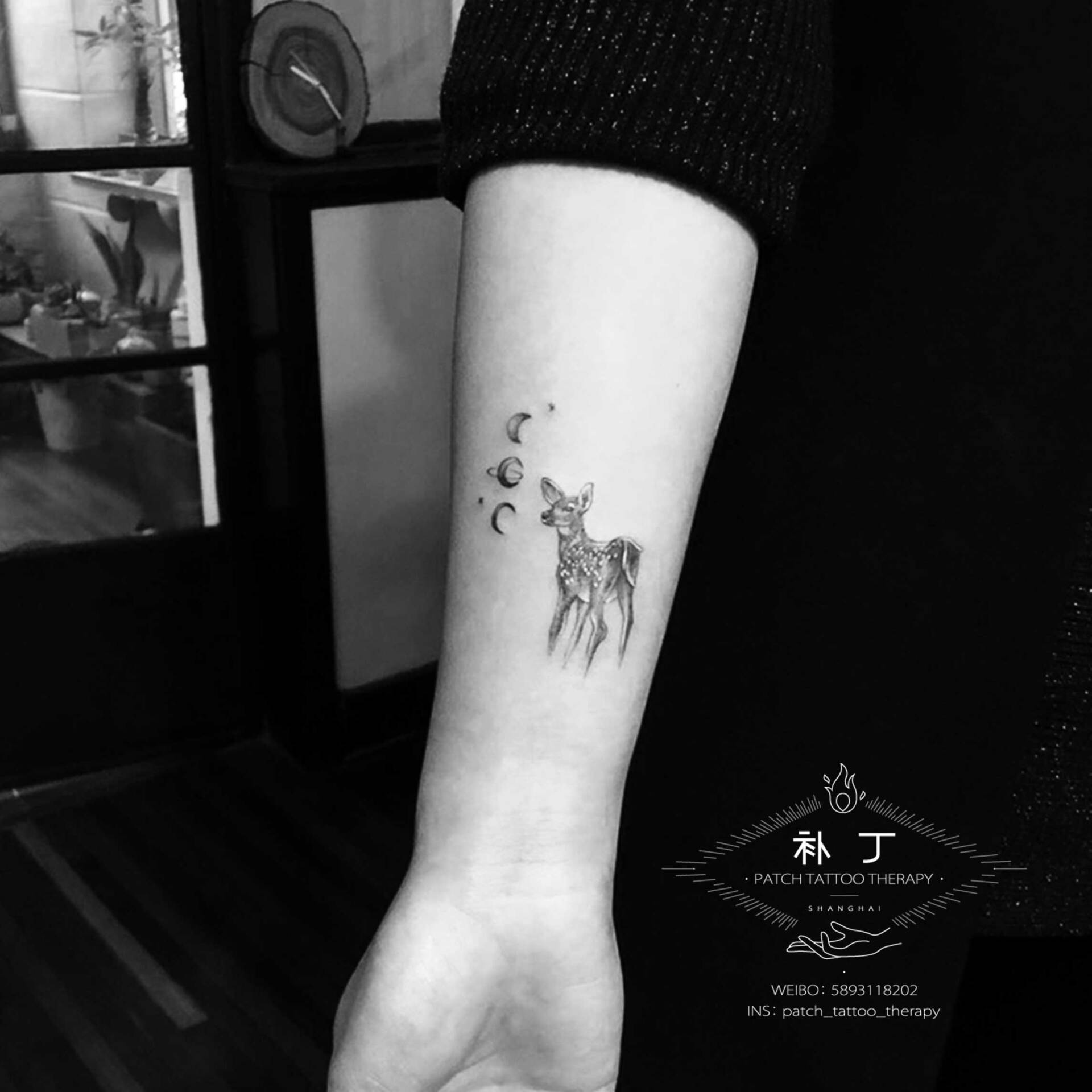 Inner forearm tattoo of a deer and moon phases in geometric style designed by Jingxi Gu at Patch Tattoo Therapy