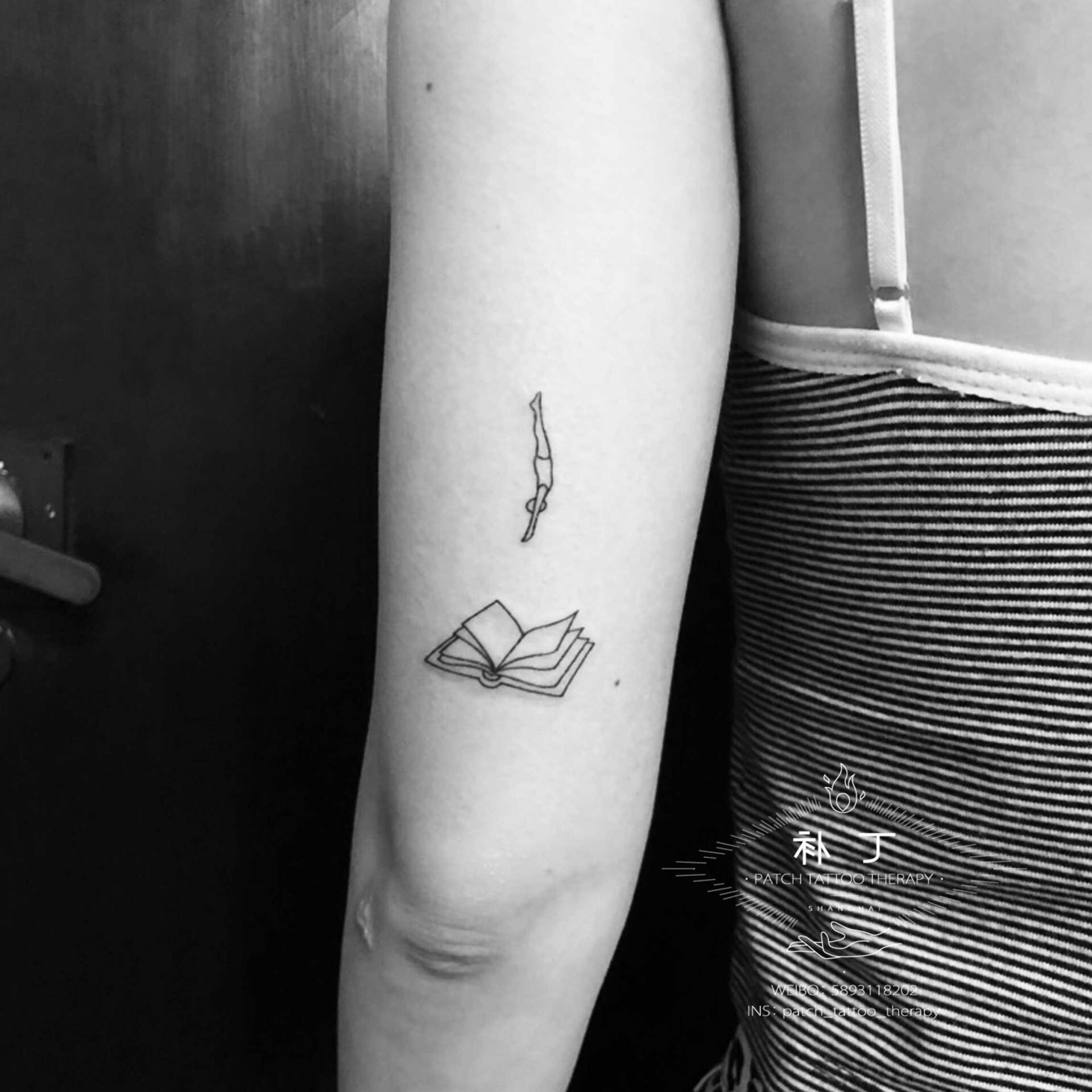 Back of upper arm tattoo of a man jumping into a book in simple outside format designed by Jingxi Gu at Patch Tattoo Therapy