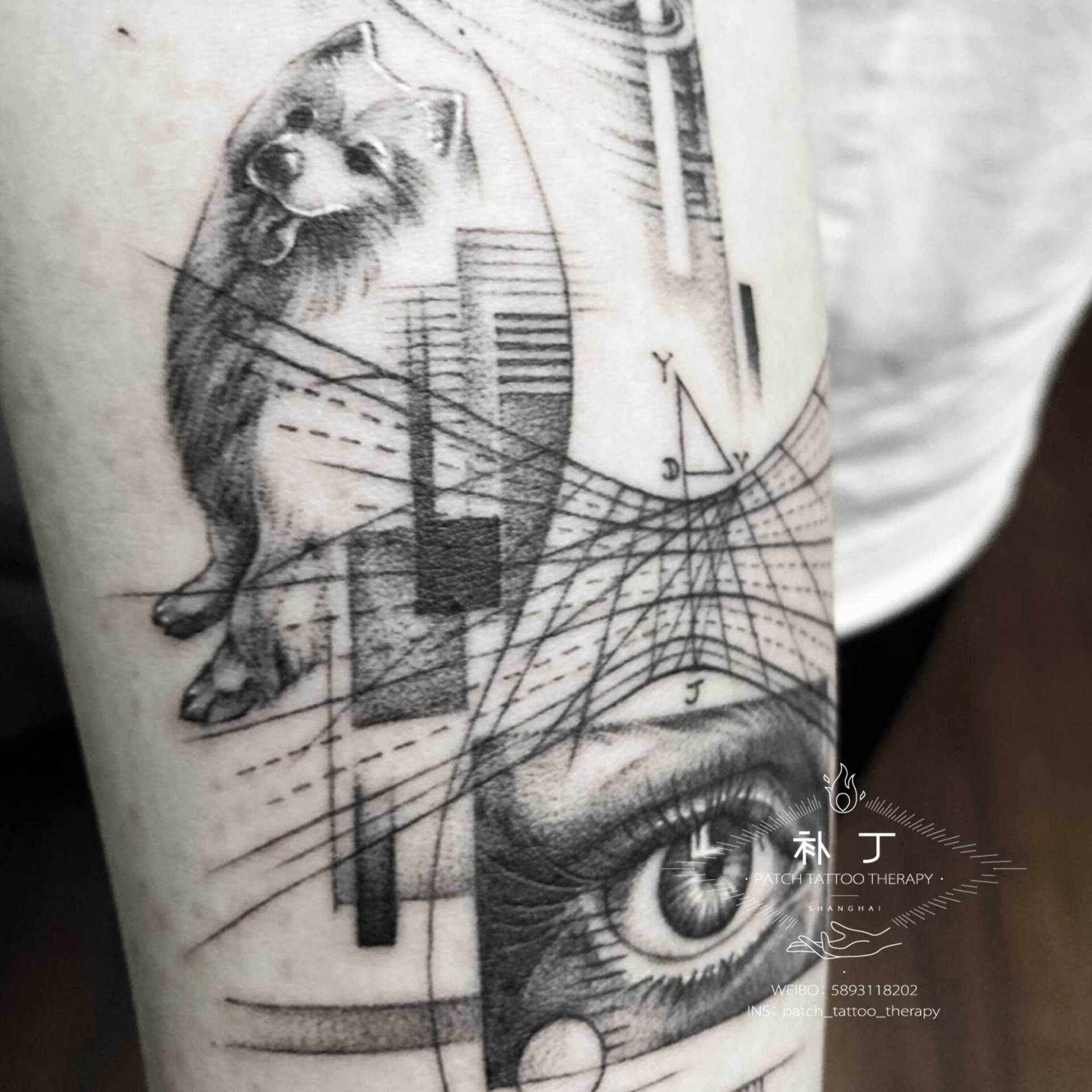 Inner forearm tattoo featuring an eye, a dog, and space elements in geometric style designed by Jingxi Gu at Patch Tattoo Therapy - angle 1