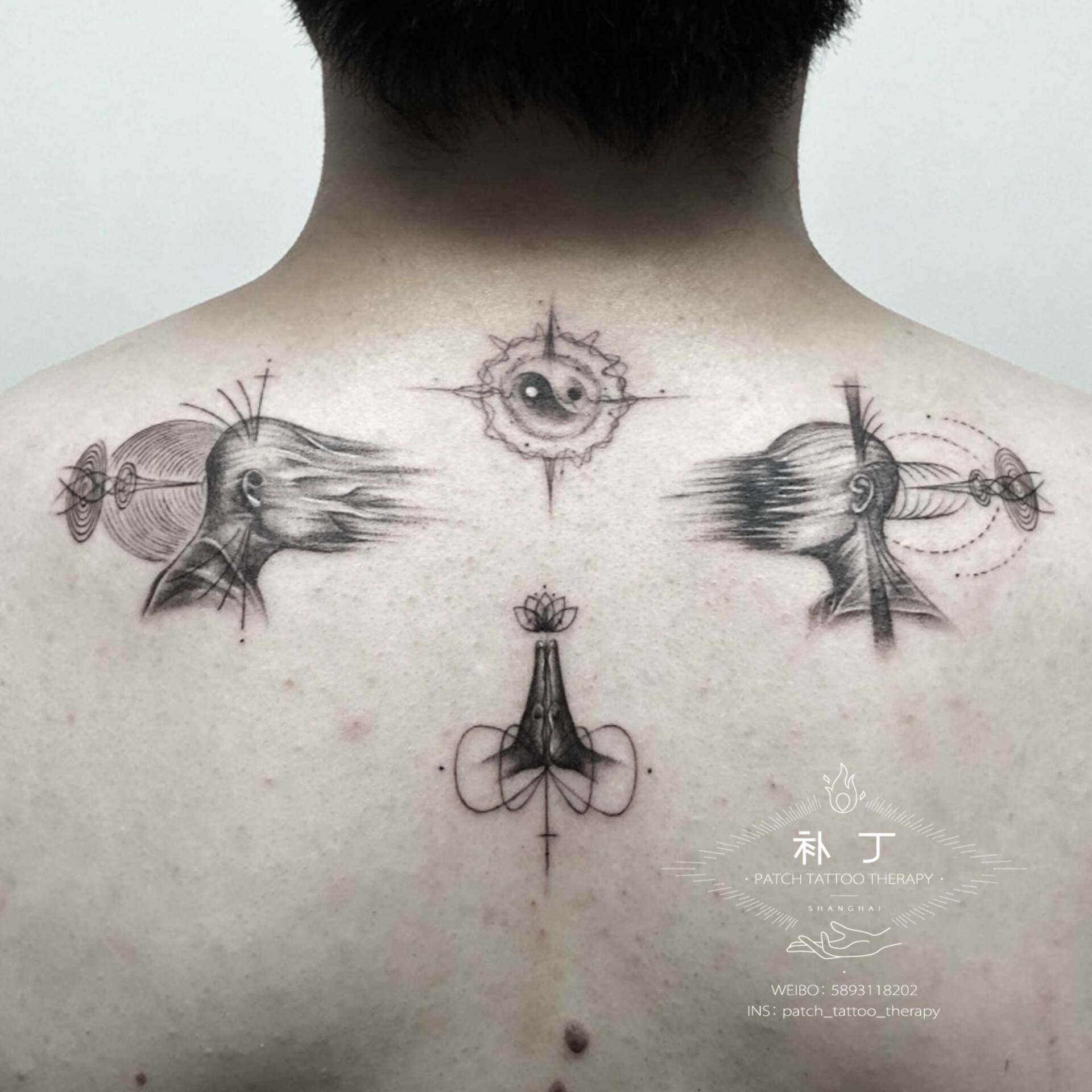 Back tattoo of two faces melting away from each other in geometric style designed by Jingxi Gu at Patch Tattoo Therapy - angle 1