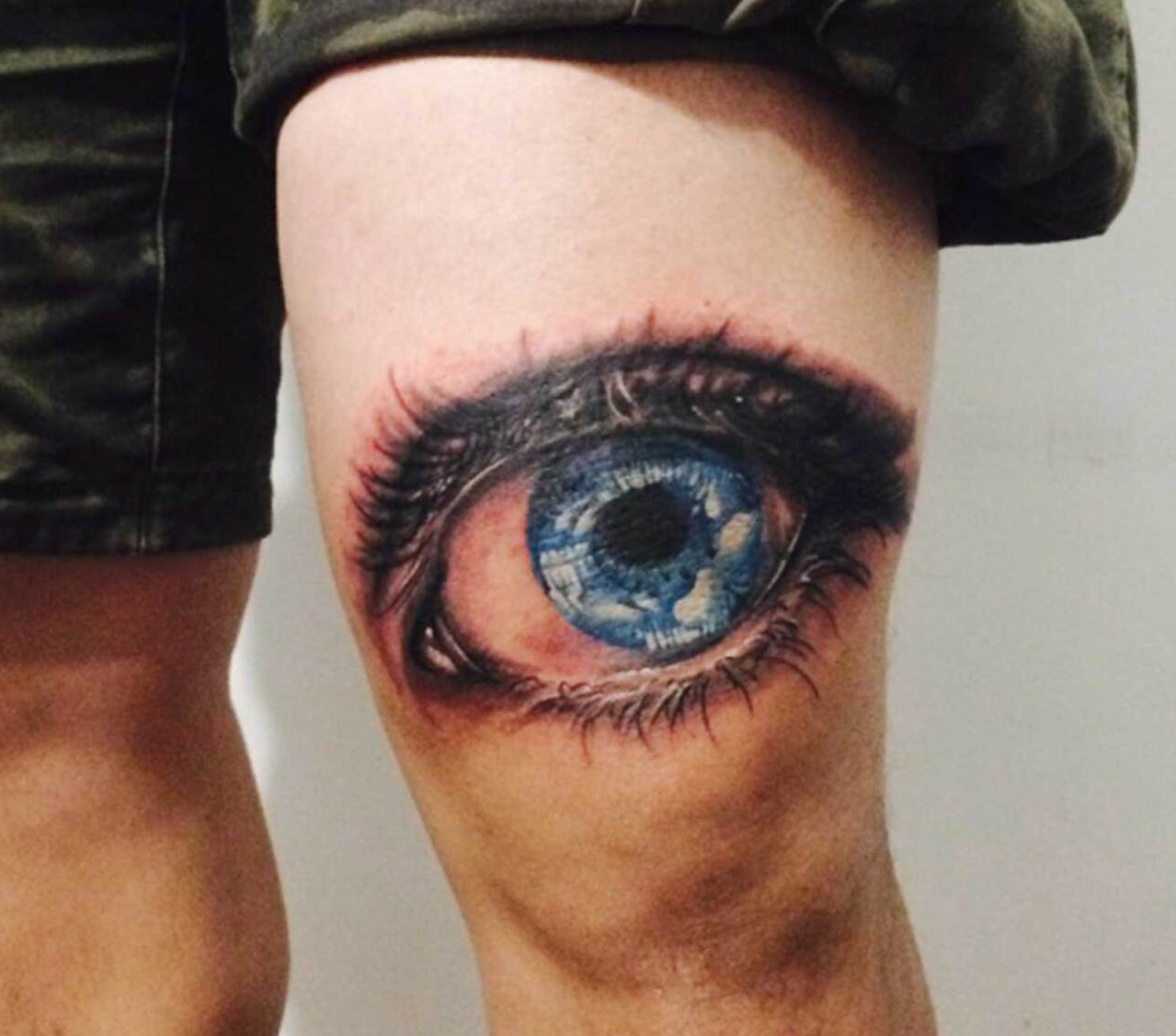 Thigh tattoo of a huge blue eye in color designed by Jingxi Gu at Patch Tattoo Therapy