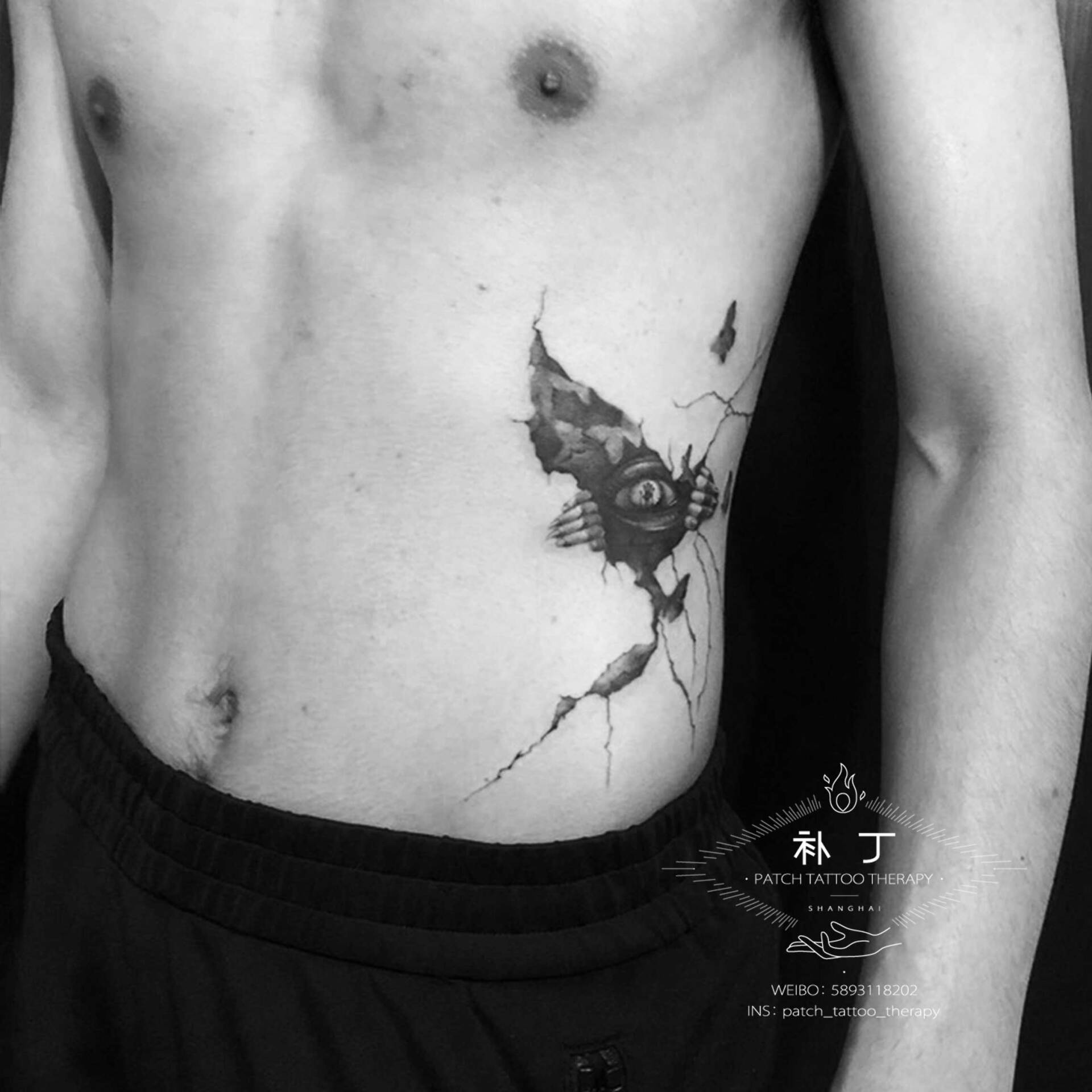 Side rib tattoo of an eye crawlling out of a body in black and grey realistic style designed by Jingxi Gu at Patch Tattoo Therapy