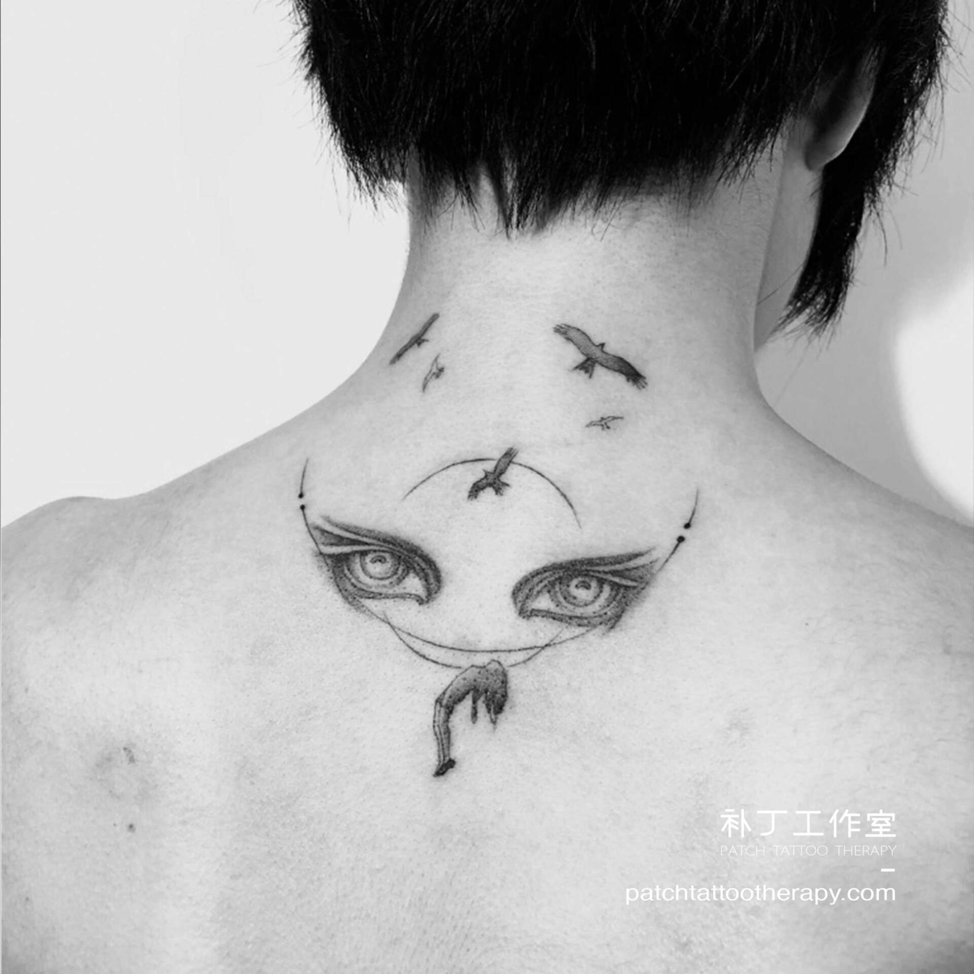 Back and neck tattoo of a girl falling with eyes watching and birds flying in geometric style designed by Jingxi Gu at Patch Tattoo Therapy - angle 1