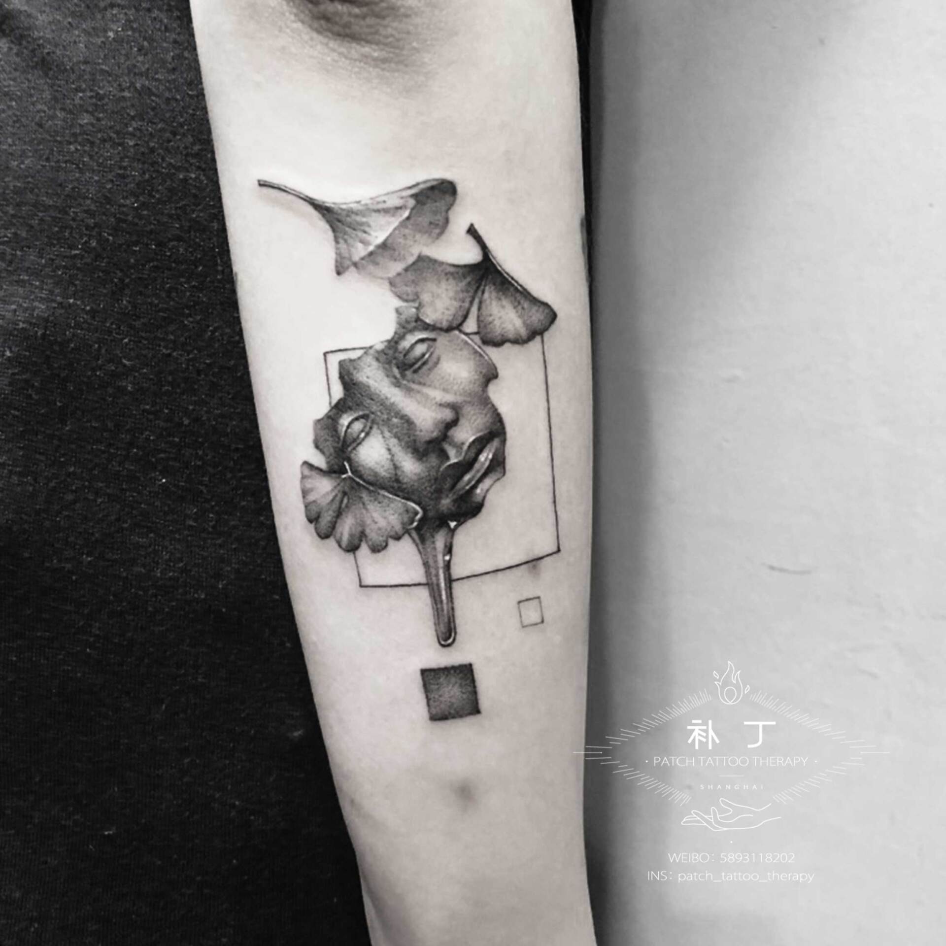 Forearm tattoo of a roman statue's face melting with ginko leaves in geometric style designed by Jingxi Gu at Patch Tattoo Therapy
