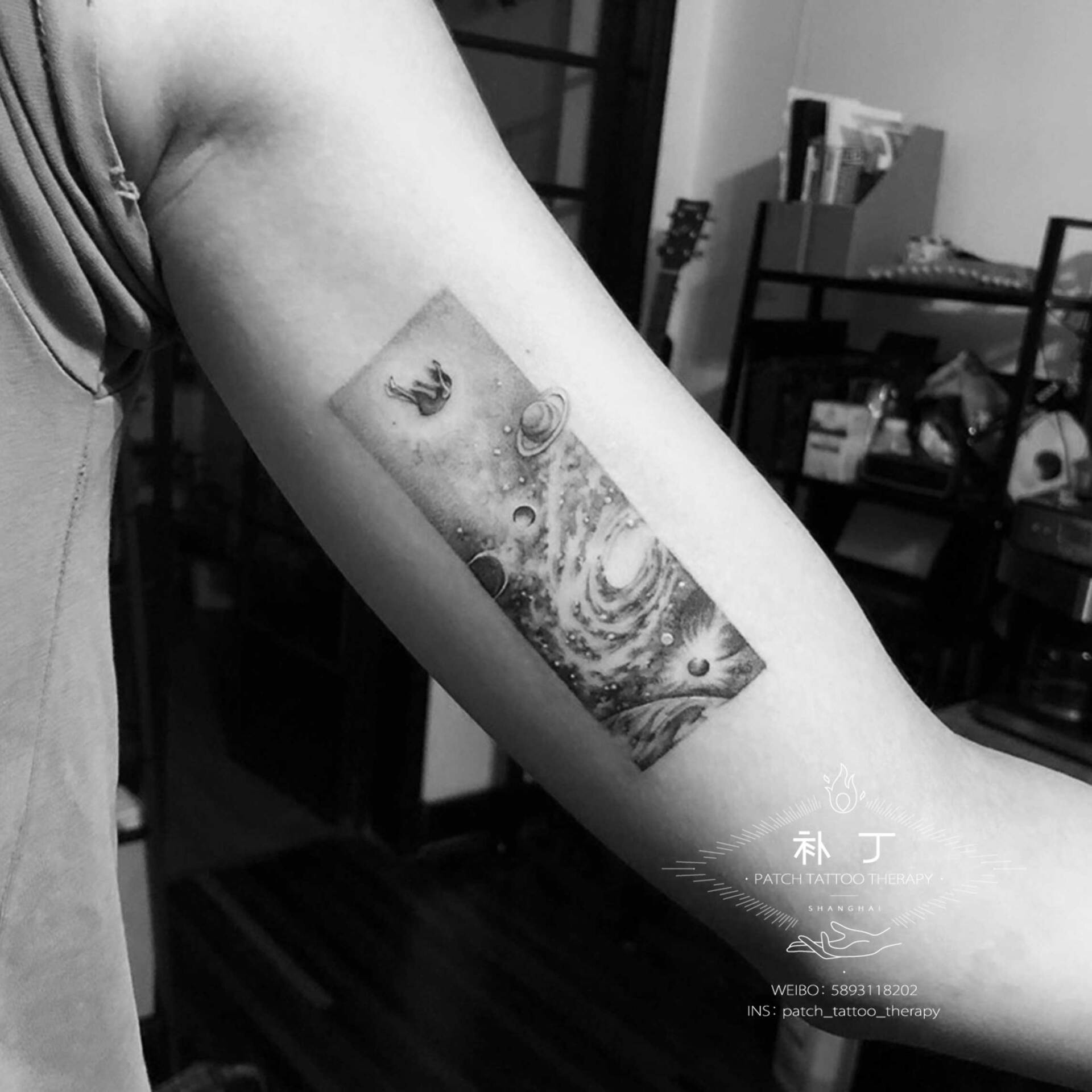 Inner arm tattoo of a falling girl in the universe in micro mini style designed by Jingxi Gu at Patch Tattoo Therapy