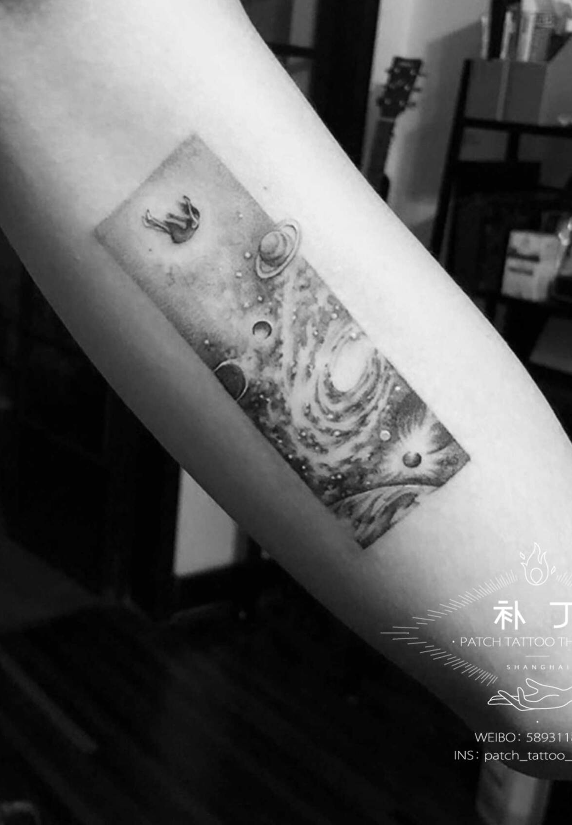 Inner arm tattoo of a falling girl in the universe in micro mini style designed by Jingxi Gu at Patch Tattoo Therapy