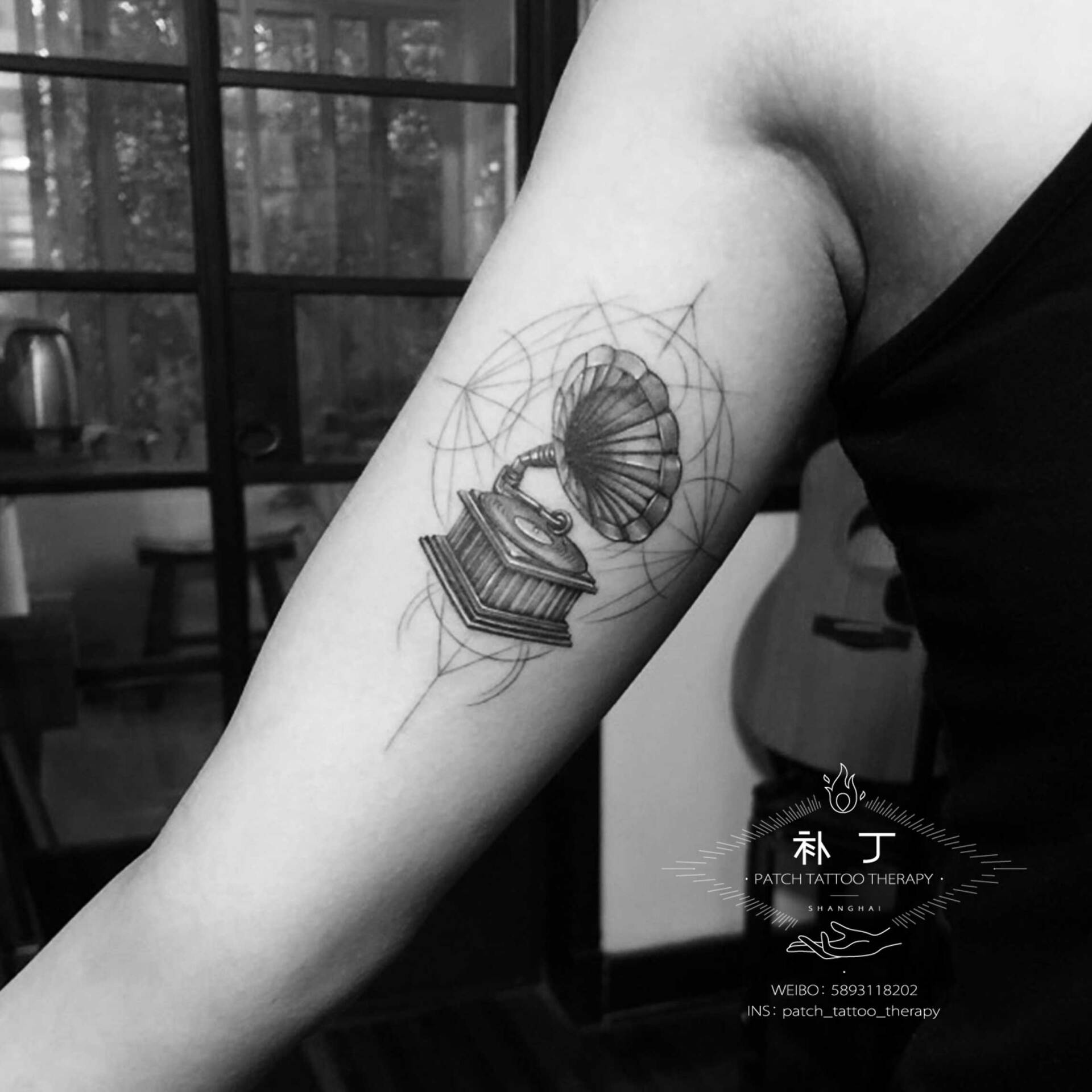 Inner arm tattoo of a gramophone in geometric style designed by Jingxi Gu at Patch Tattoo Therapy