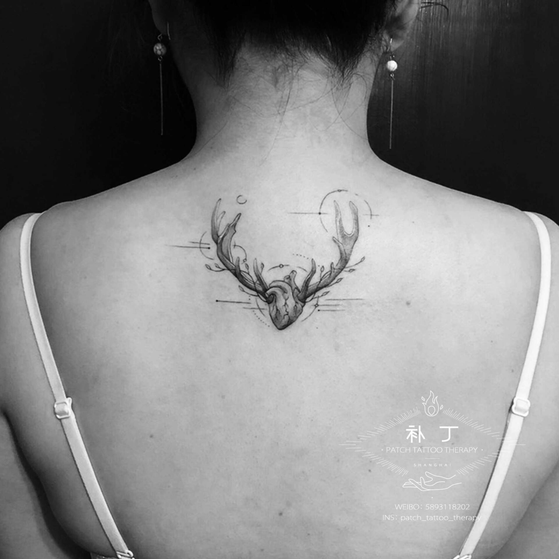 Back tattoo of a heart with antlers presenting the heart and soul of a deer in geometric style designed by Jingxi Gu at Patch Tattoo Therapy