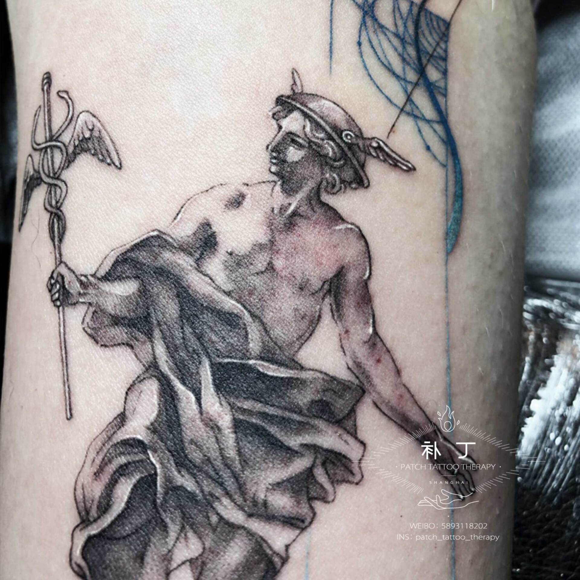Inner arm tattoo of Hermes in a graceful pose done in geometric style with some colors designed by Jingxi Gu at Patch Tattoo Therapy - angle 2