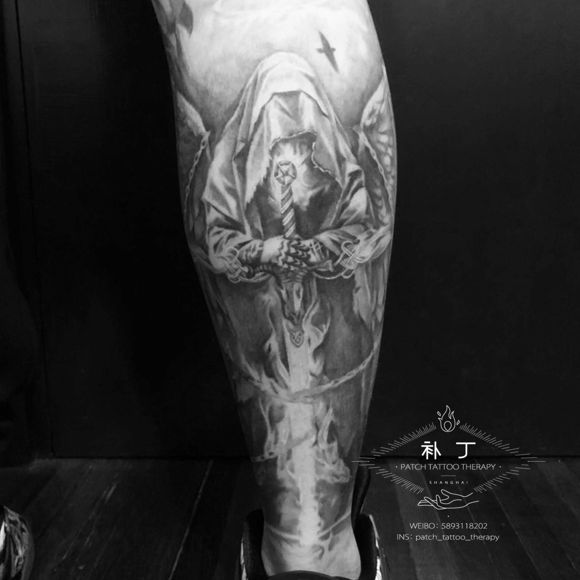 Back calf tattoo of a hooded warrior in black and grey realistic style designed by Jingxi Gu at Patch Tattoo Therapy - angle 1