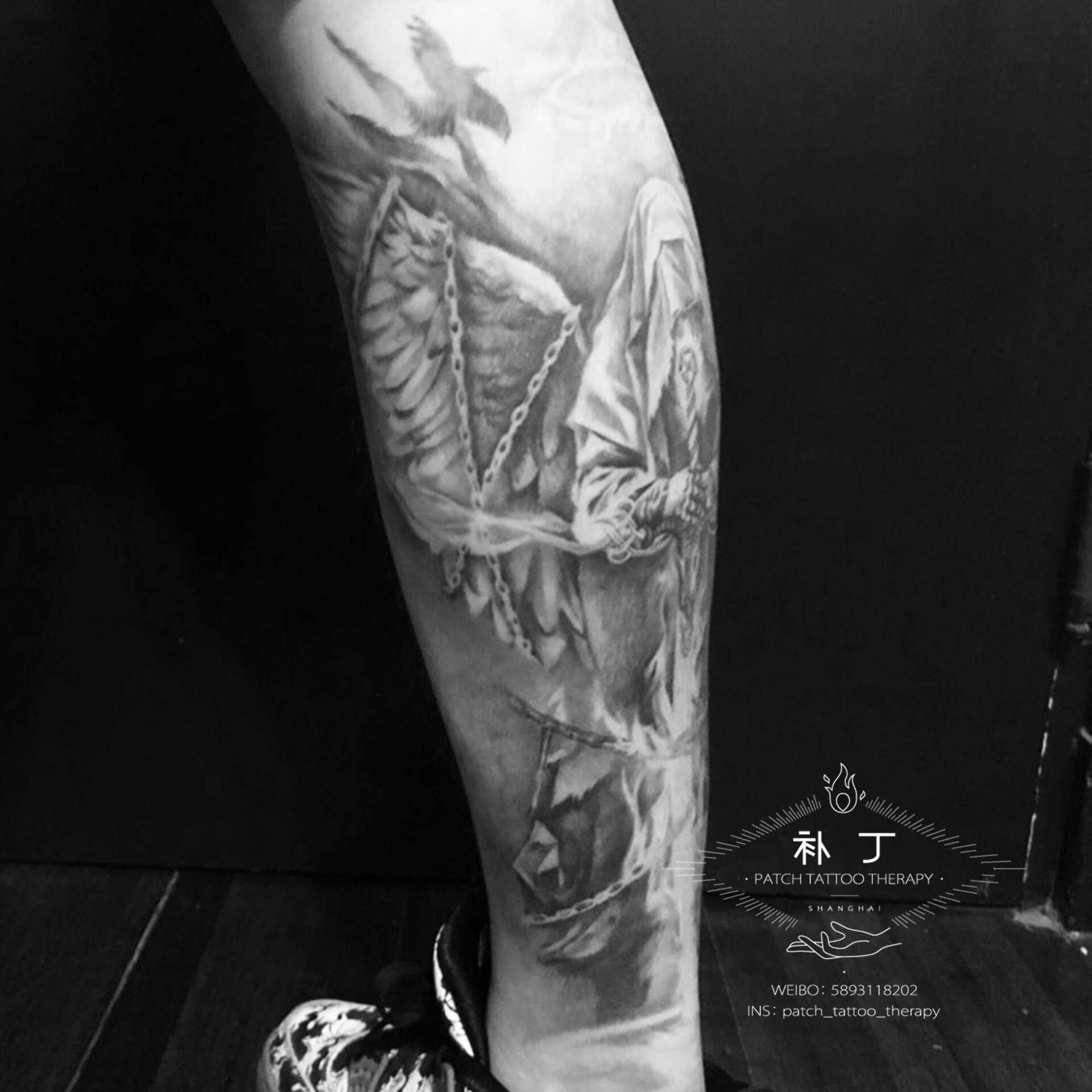 Back calf tattoo of a hooded warrior in black and grey realistic style designed by Jingxi Gu at Patch Tattoo Therapy - angle 2
